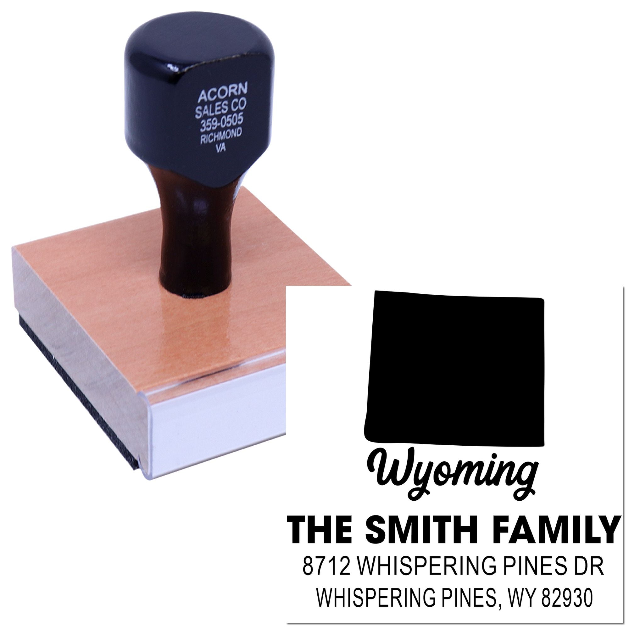 Custom Wyoming self-inking address stamp with state silhouette, family name and address, shown on a wooden base against a white background.