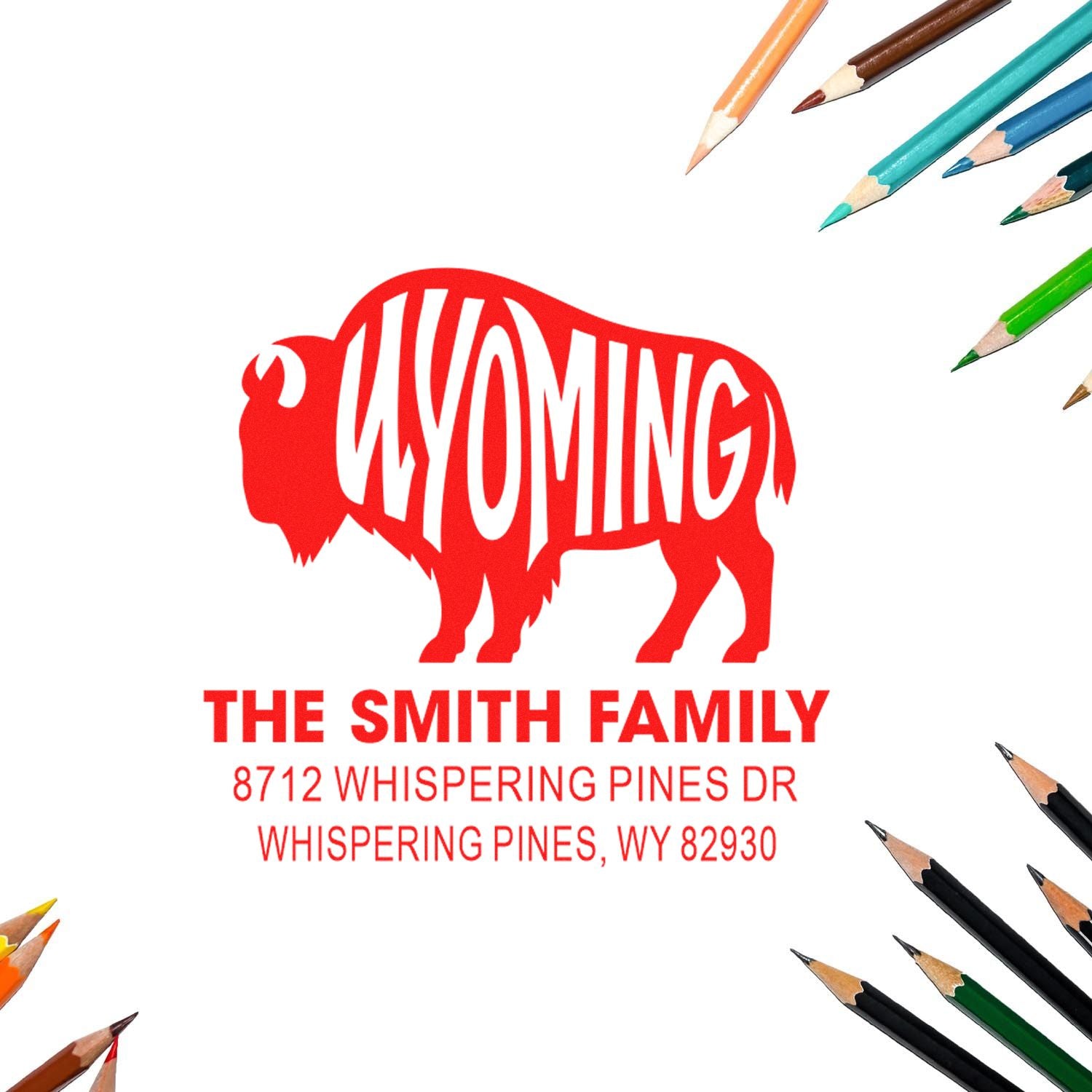 Custom Wyoming bison address stamp with The Smith Family name and Whispering Pines, WY address, framed by colored pencils on a white background.