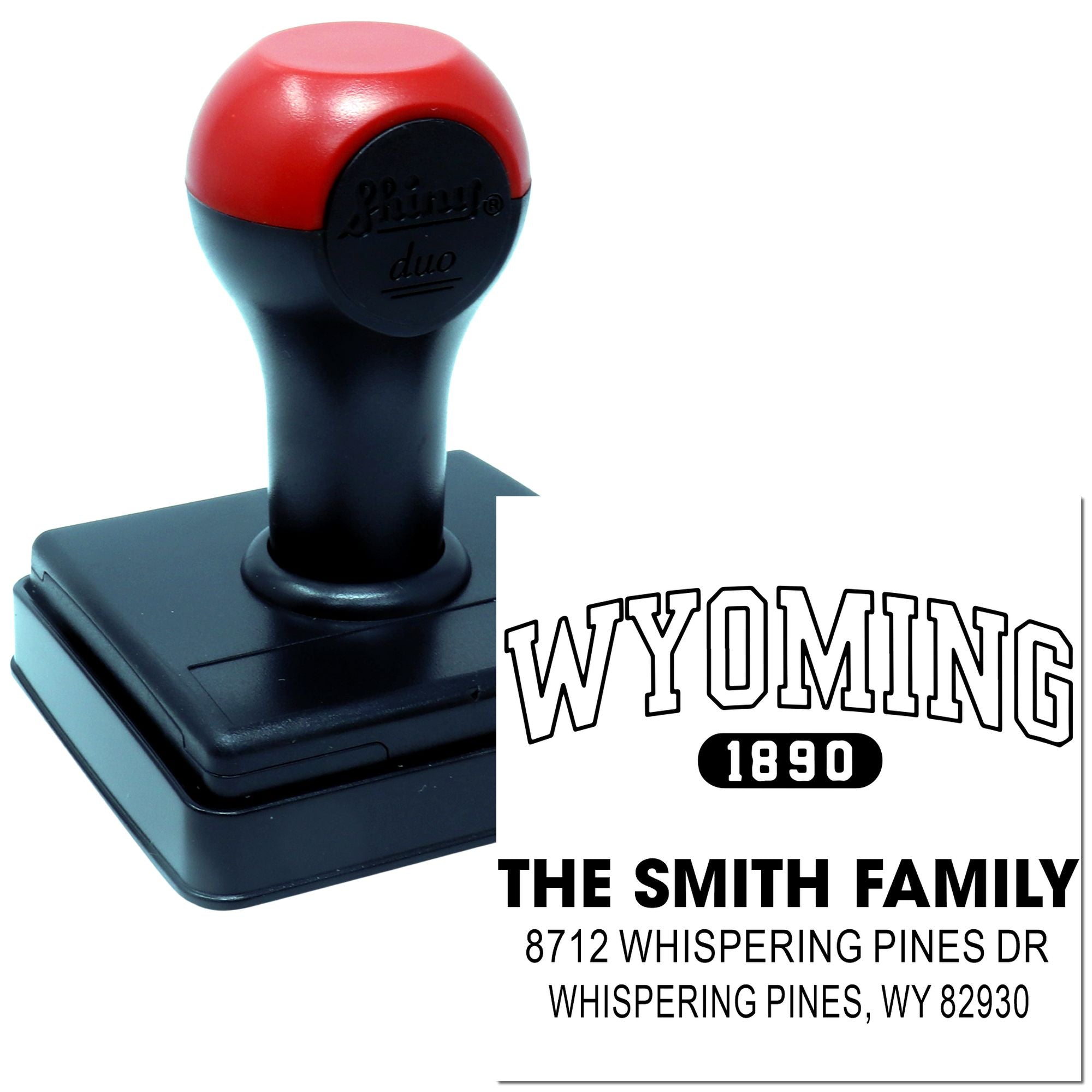 Custom self-inking address stamp with red and black handle, showing Wyoming 1890 design and The Smith Family return address imprint on white background.