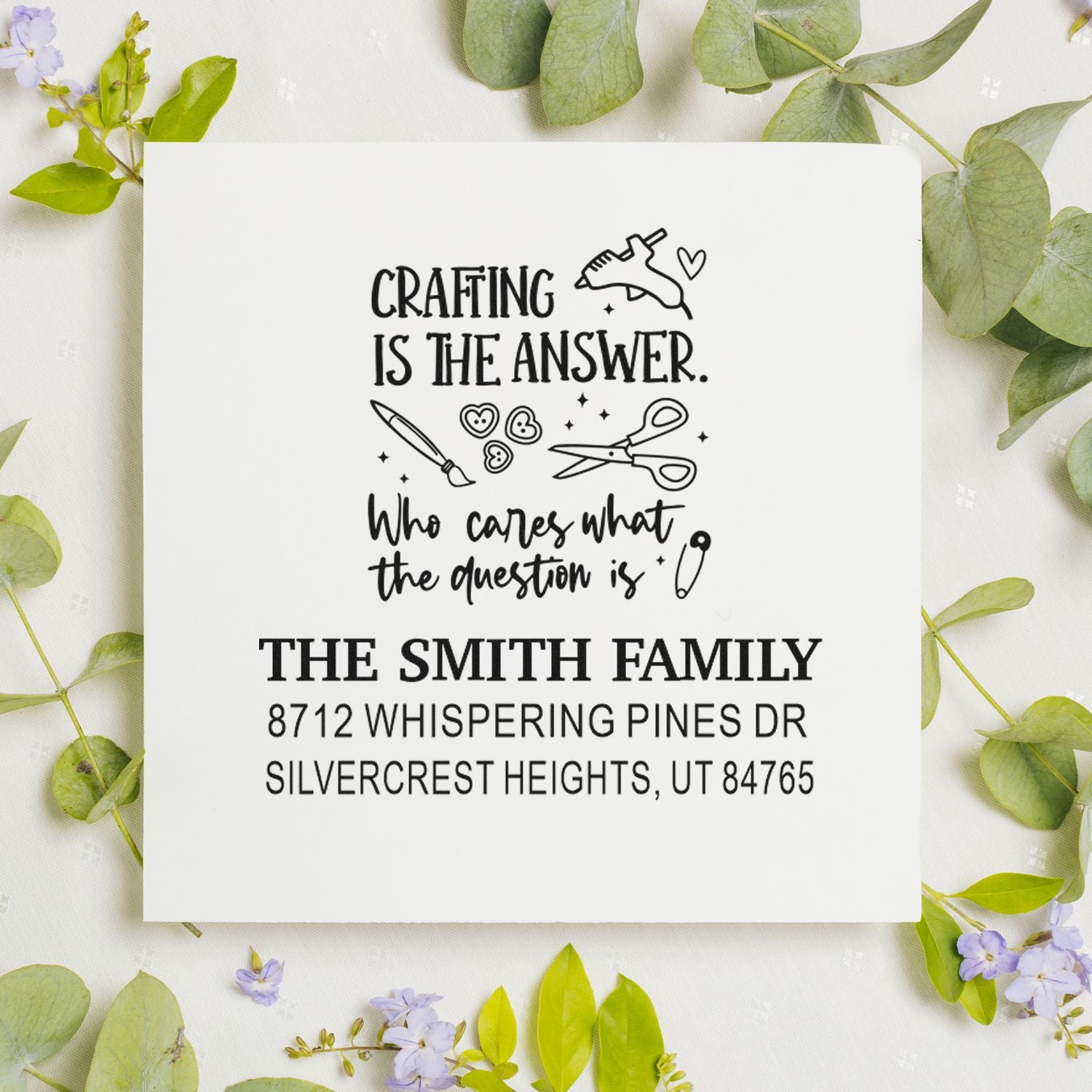 Custom craft-themed family address stamp with Crafting is the answer quote, scissors and paintbrush, shown on white card with eucalyptus.