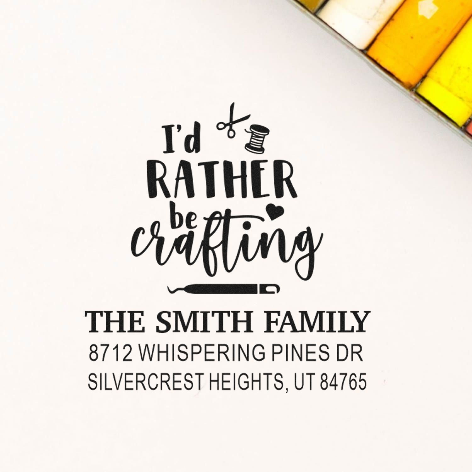 Custom crafting address stamp on white paper, featuring scissors, thread spool and needle with Id rather be crafting for The Smith Family.