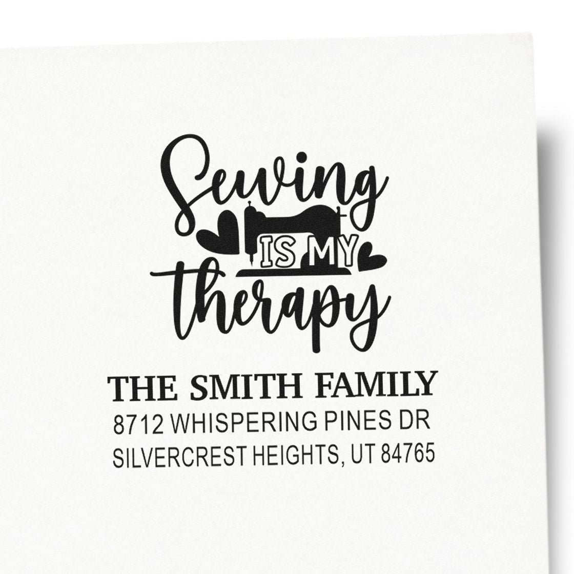 Custom address stamp with sewing machine and Sewing is my therapy design, featuring The Smith Family return address on white paper.