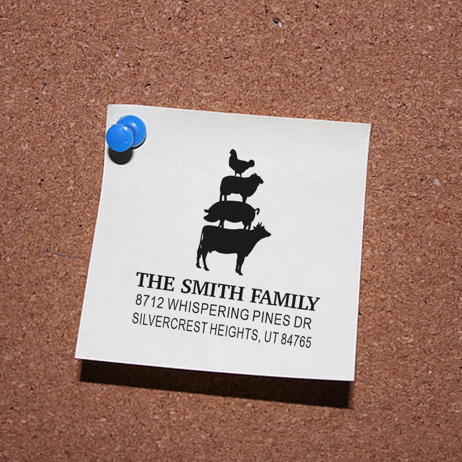 Personalized family address stamp on a corkboard, featuring stacked farm animal silhouettes above the Smith family name and Utah address, pinned with blue tacks.