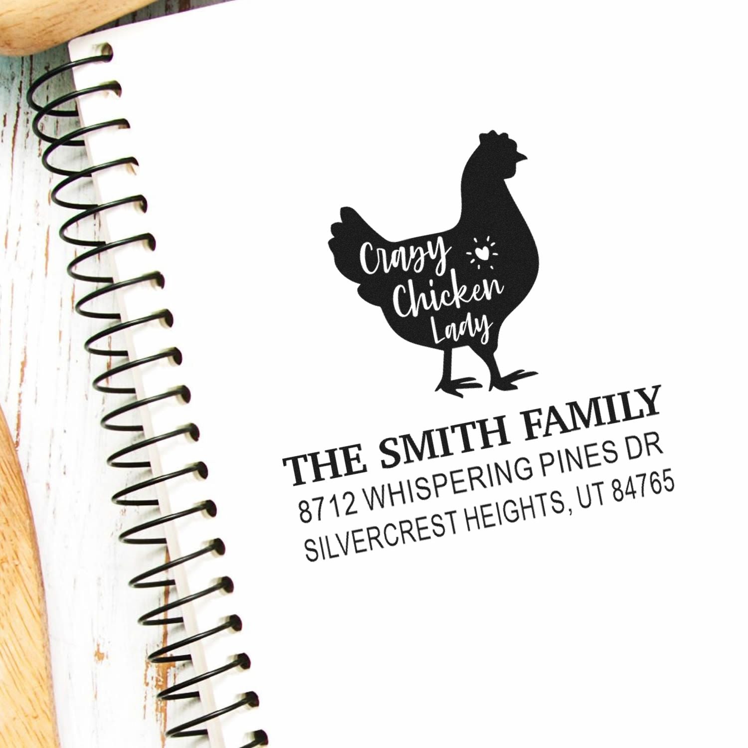 Custom chicken lady address stamp with chicken silhouette and return address on spiral notebook, personalized for The Smith Family.