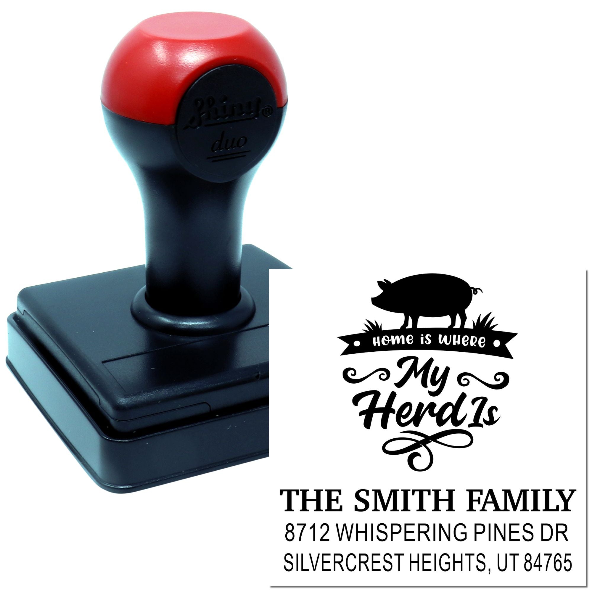 Custom self-inking address stamp with pig design and Home is where My Herd Is text, shown beside sample imprint for The Smith Family.