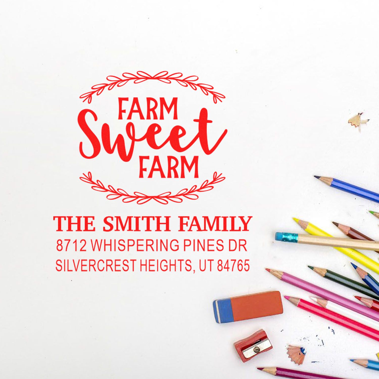 Personalized Farm Sweet Farm address stamp for The Smith Family, with Silvercrest Heights, UT, on a white desk beside colored pencils.