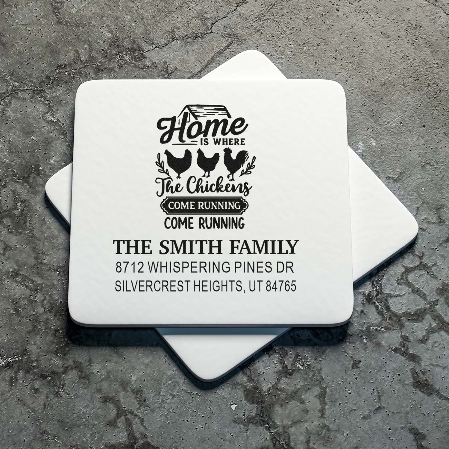 Custom farmhouse chicken address stamps with Home is where the chickens come running for The Smith Family on a gray stone surface.
