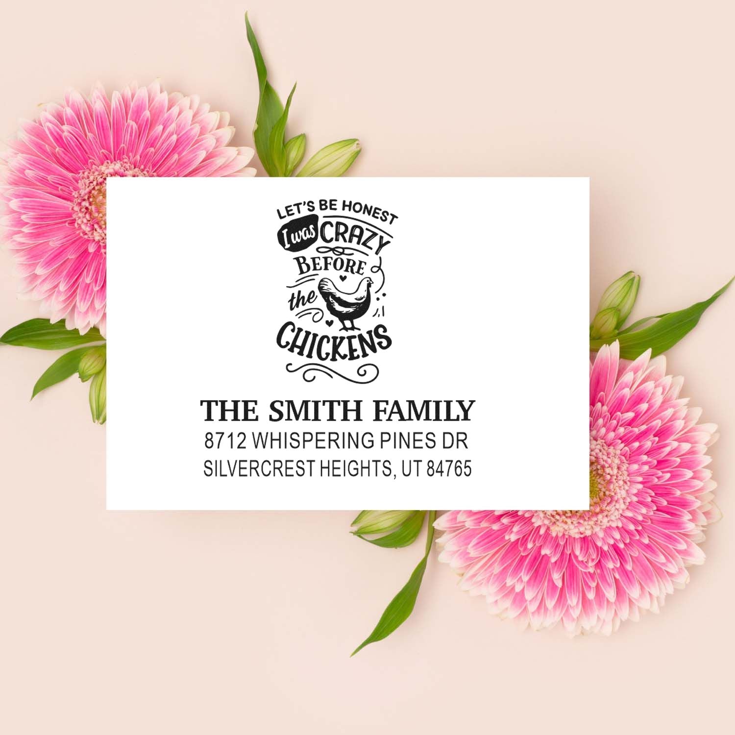 Custom address stamp with funny chicken design and Smith family address, displayed on white card with pink flowers on a beige background.