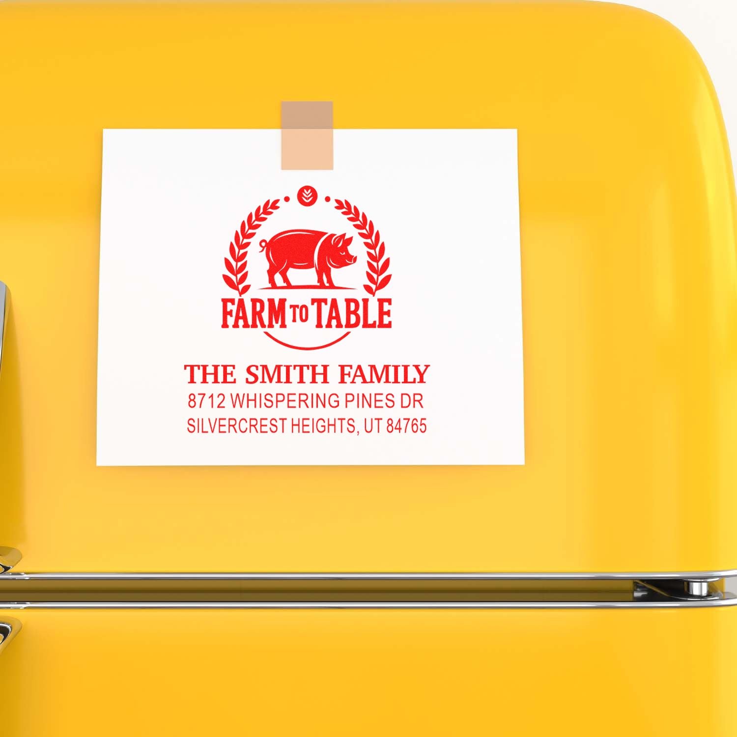 Custom farm-to-table address stamp with pig logo on a white card taped to a bright yellow retro refrigerator.