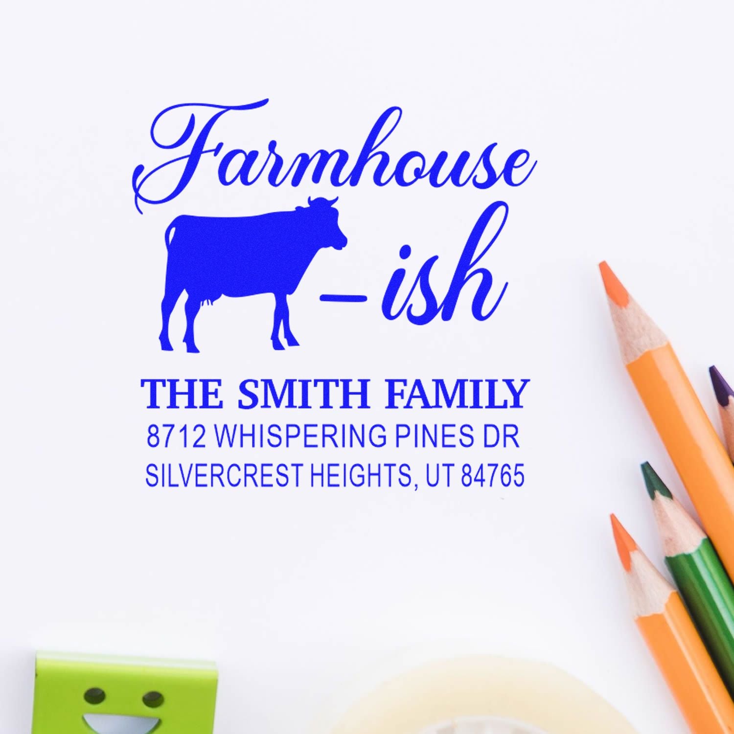 Custom farmhouse address stamp with cow silhouette, Smith Family name, and Utah address on white paper with colored pencils.
