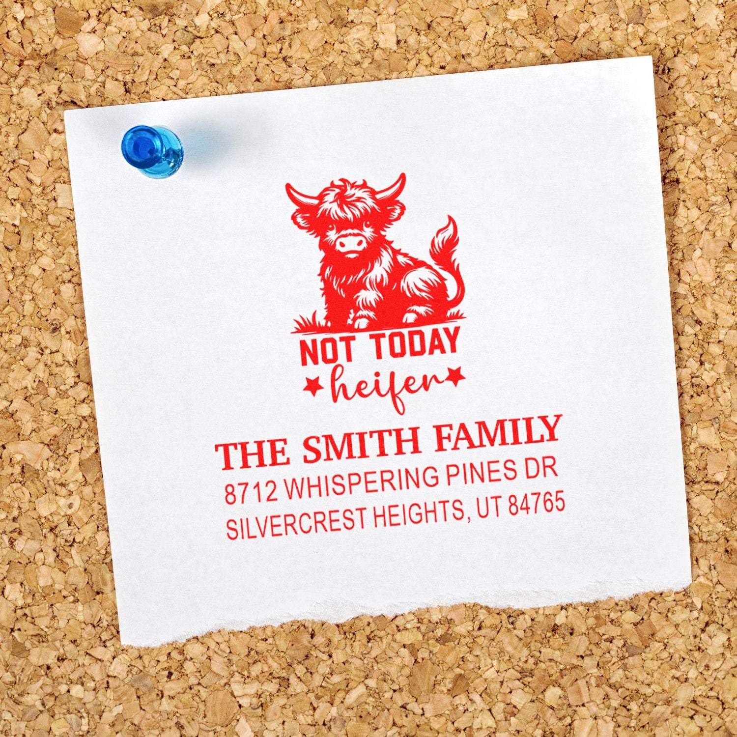 Custom address stamp with red Not Today Heifer cattle design on white paper pinned to a corkboard, featuring Smith family address details.
