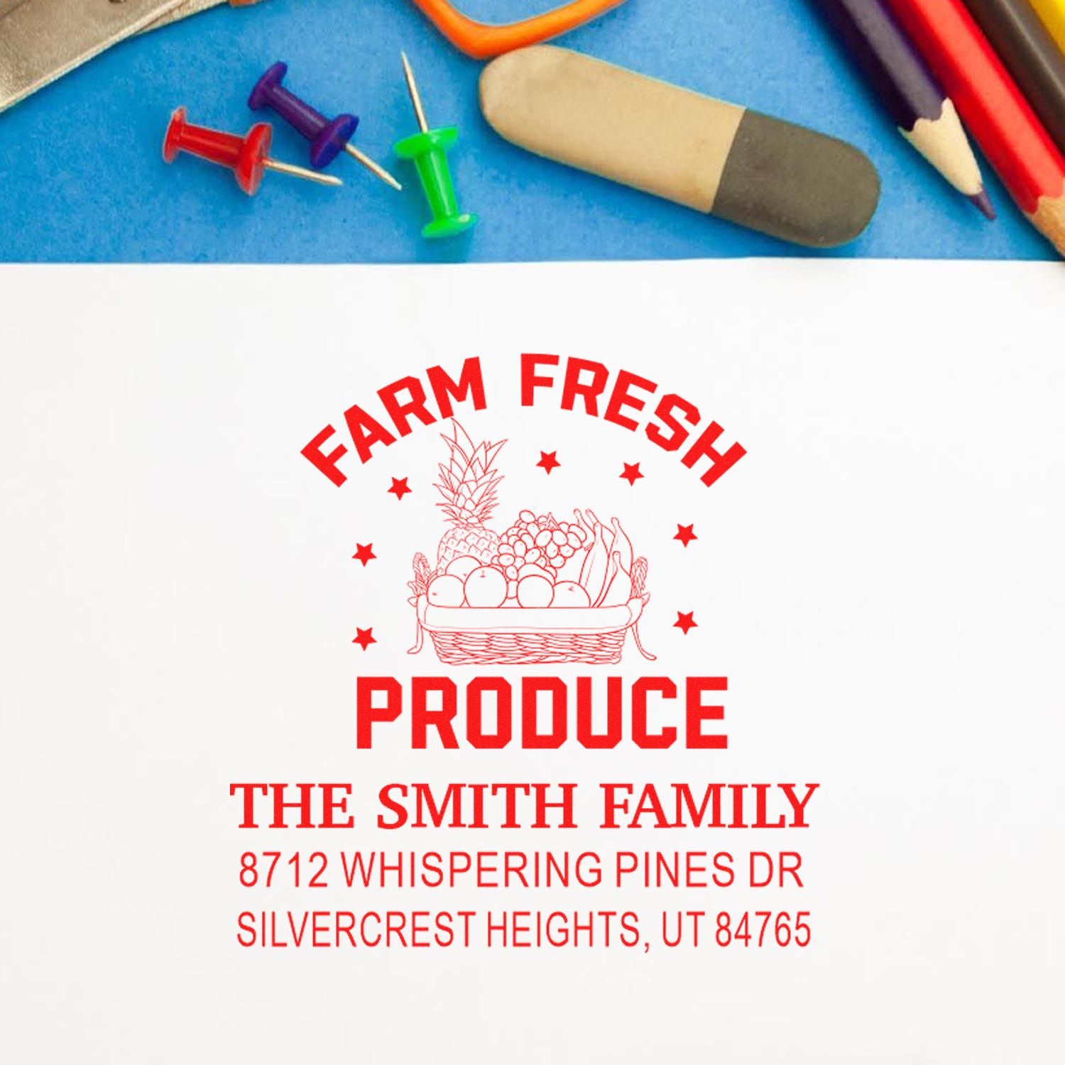 Custom farm fresh produce address stamp on white paper, with basket logo and Smith family address, on a blue desk with push pins and pencils.