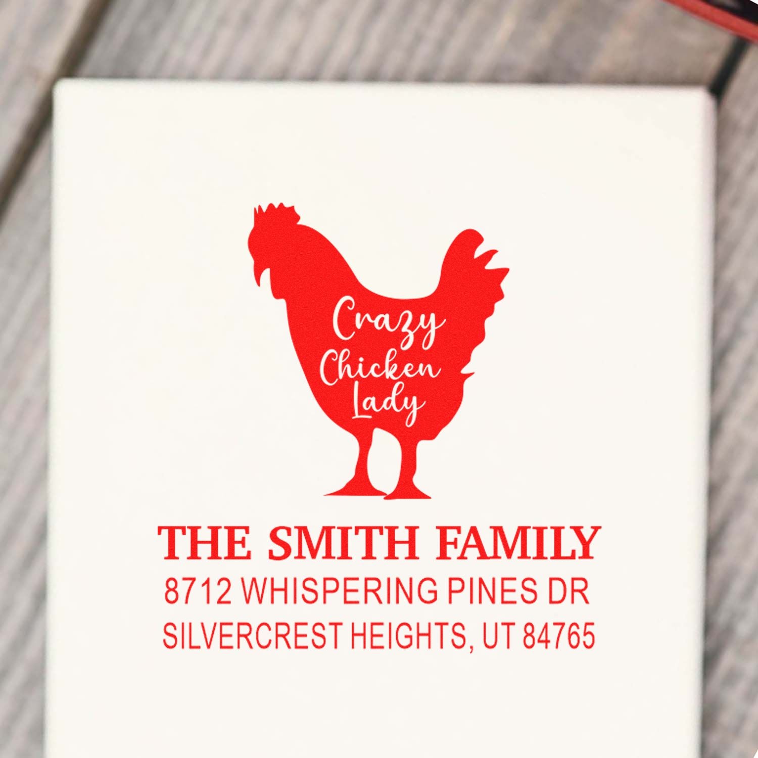 Custom red Crazy Chicken Lady address stamp for The Smith Family, with rooster silhouette and home address on white packaging.