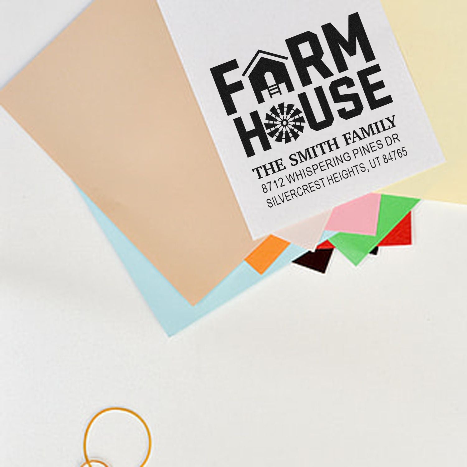 Custom farmhouse return address stamp on stacked colorful envelopes with The Smith Family name and Utah address.