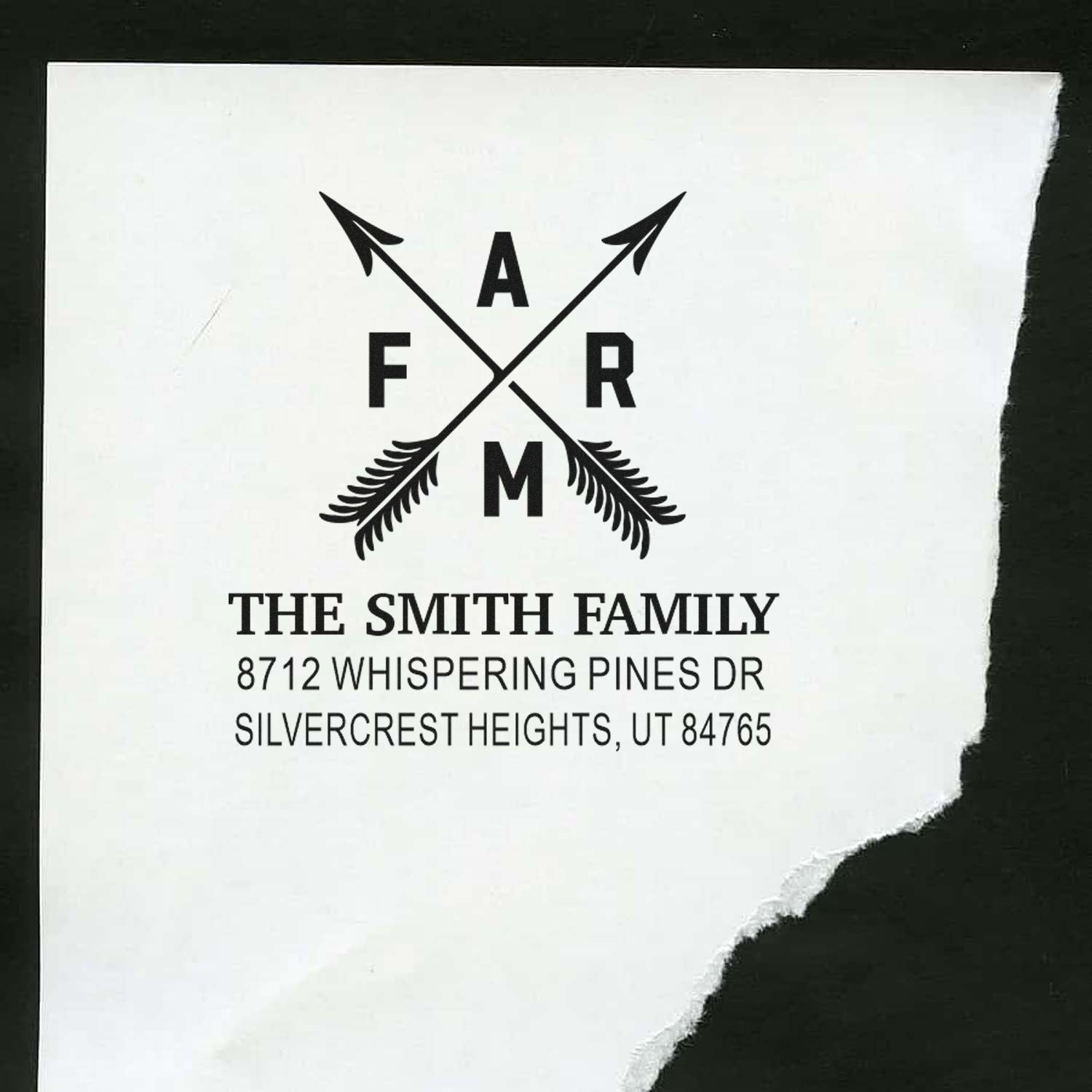 Custom family address stamp with crossed arrows monogram, reading The Smith Family and a Utah address on white paper.