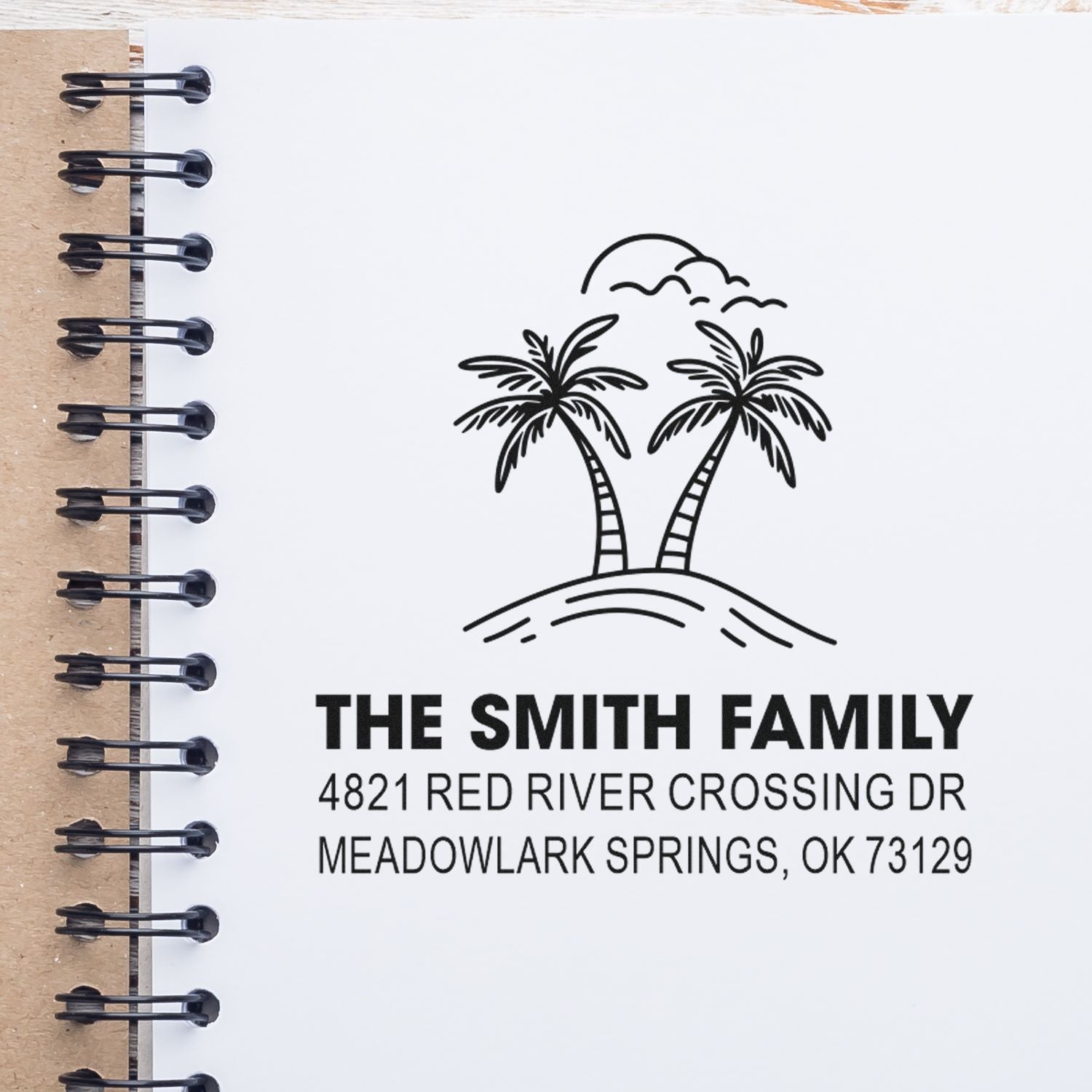 Custom family address stamp with palm trees on a notebook page, reading The Smith Family, 4821 Red River Crossing Dr, Meadowlark Springs, OK 73129.