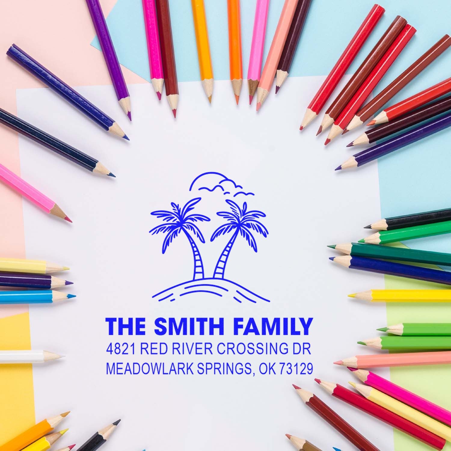 Custom family address stamp with palm tree logo, surrounded by colorful pencils on a pastel background, showcasing a personalized return address design.