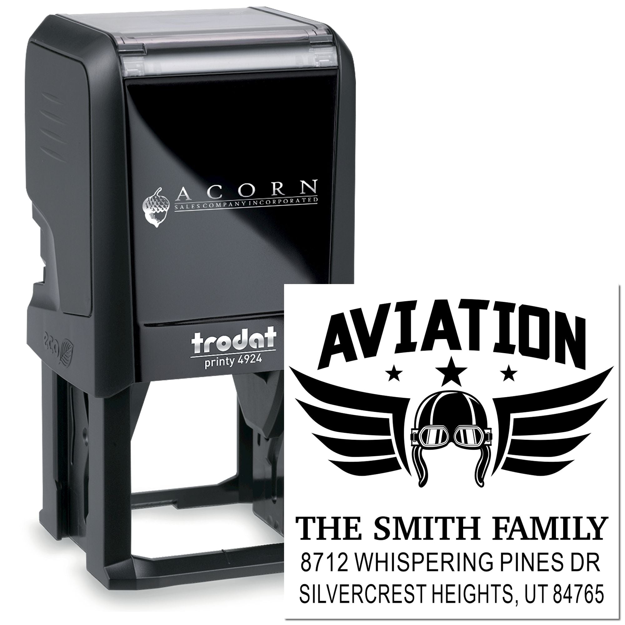 Trodat self-inking custom address stamp with aviation helmet logo and family name, shown beside the stamp impression on a white background.