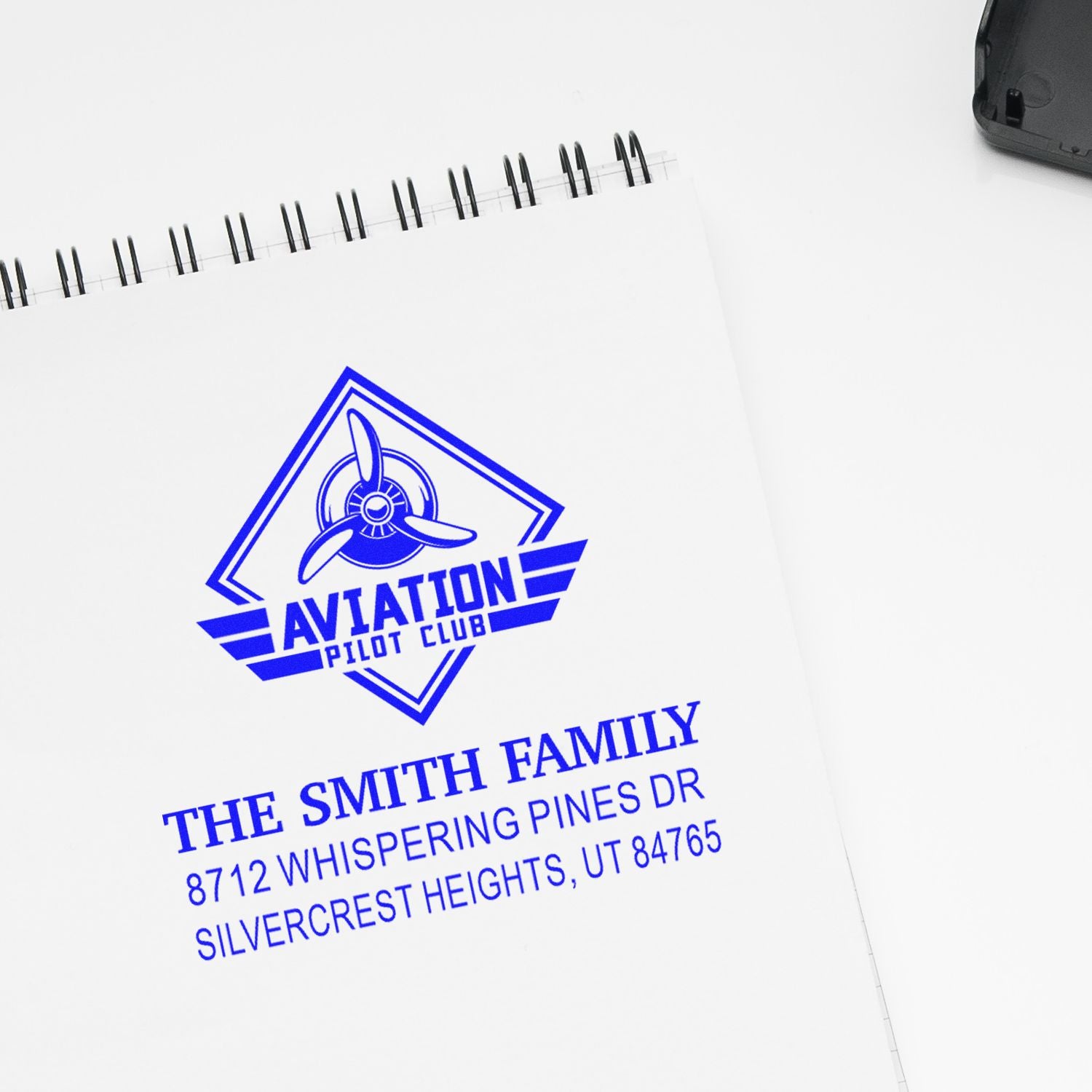 Custom aviation pilot club address stamp on a white spiral notebook, featuring The Smith Family and Silvercrest Heights, UT.