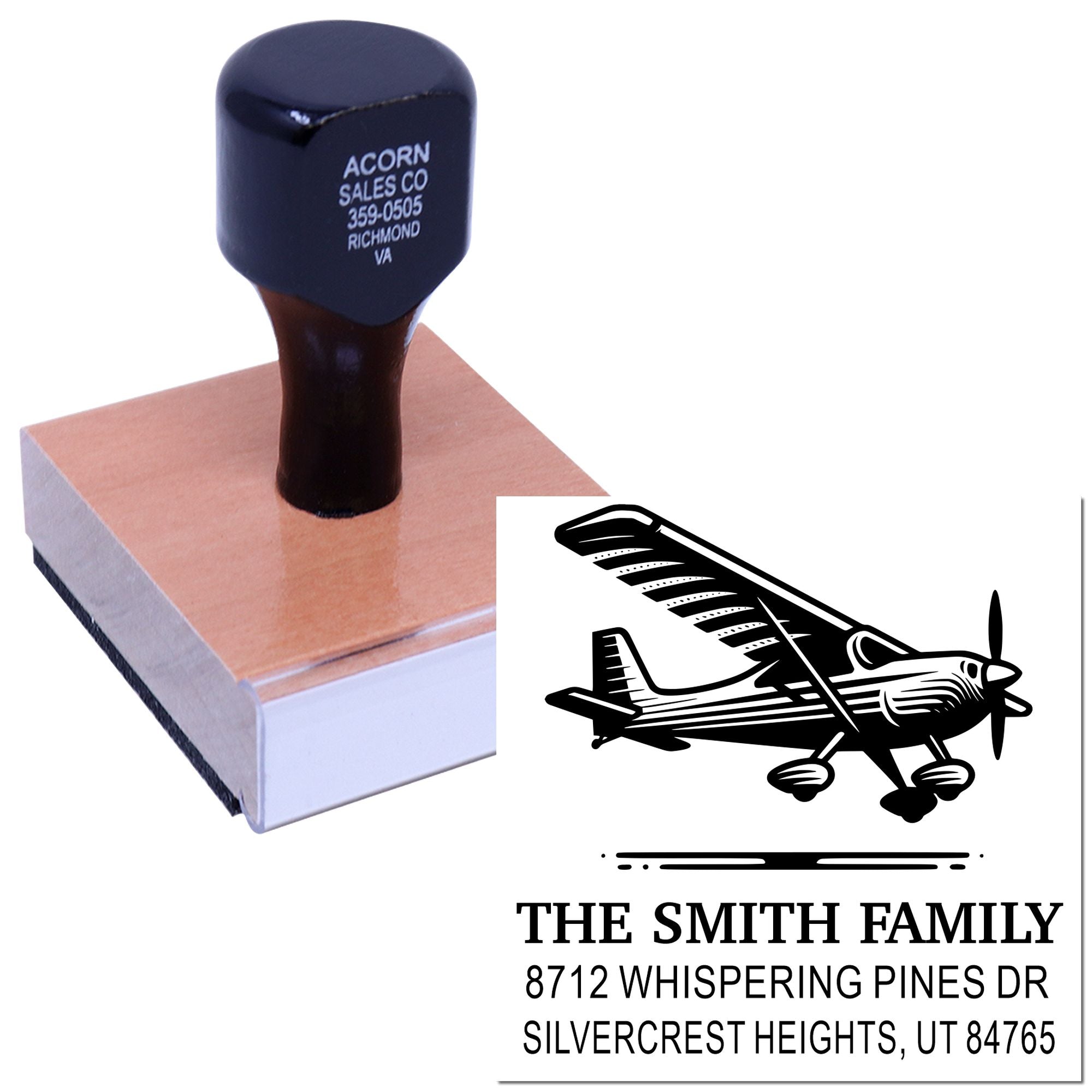 Custom return address stamp with airplane design and wood handle, shown on white background with sample impression for family mailing use.