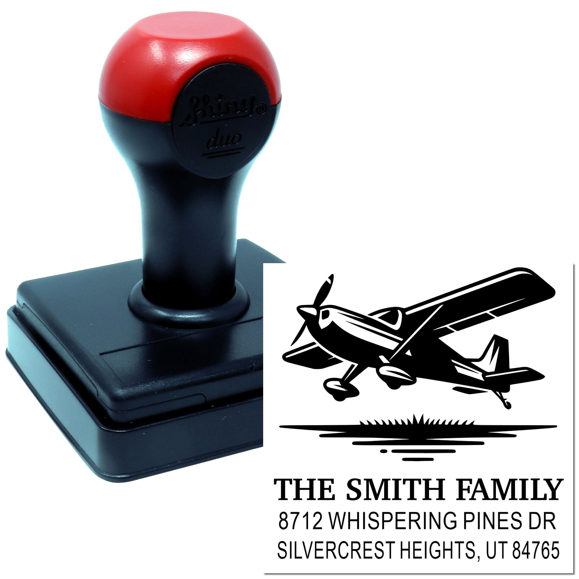 Custom self-inking address stamp with airplane graphic, showing The Smith Family and a Silvercrest Heights, UT address on a white background.