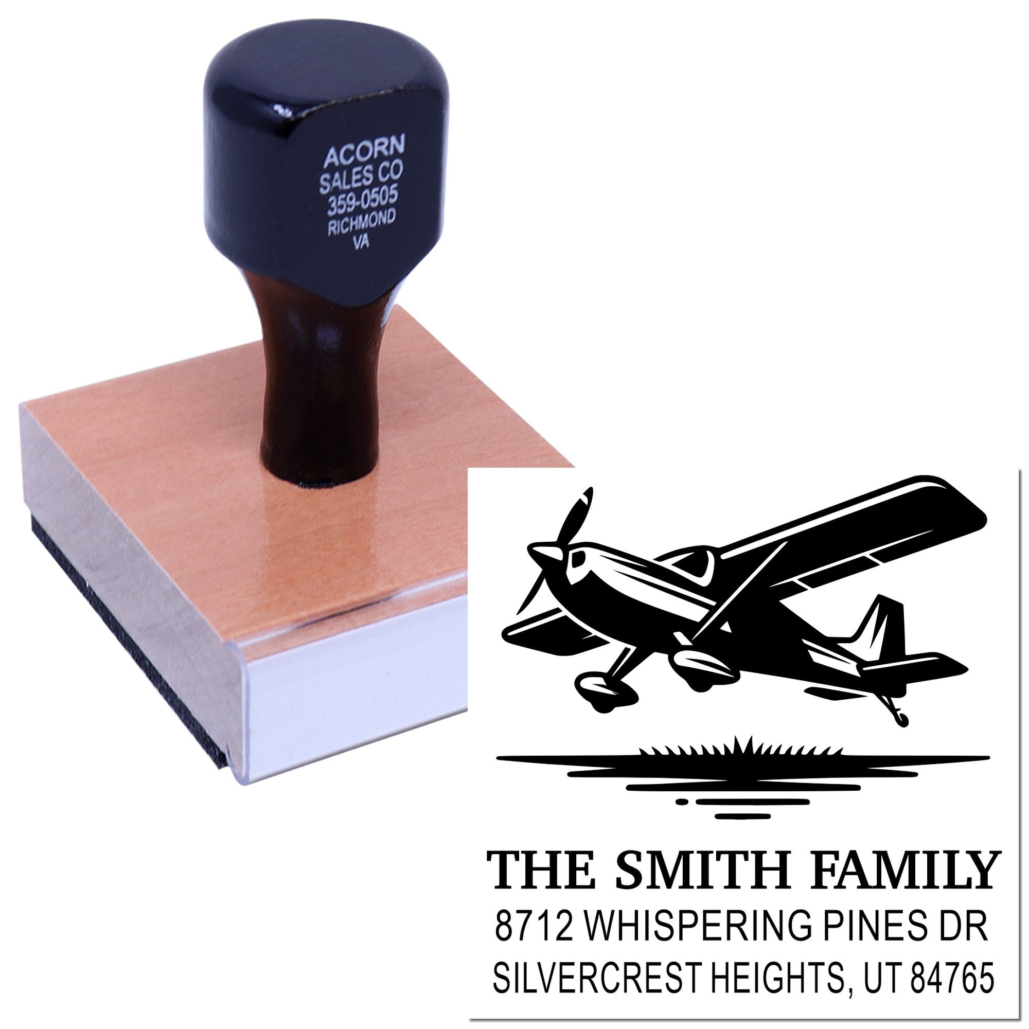 Custom rubber stamp with airplane logo and family address, shown on a wooden base with sample black imprint on white background.