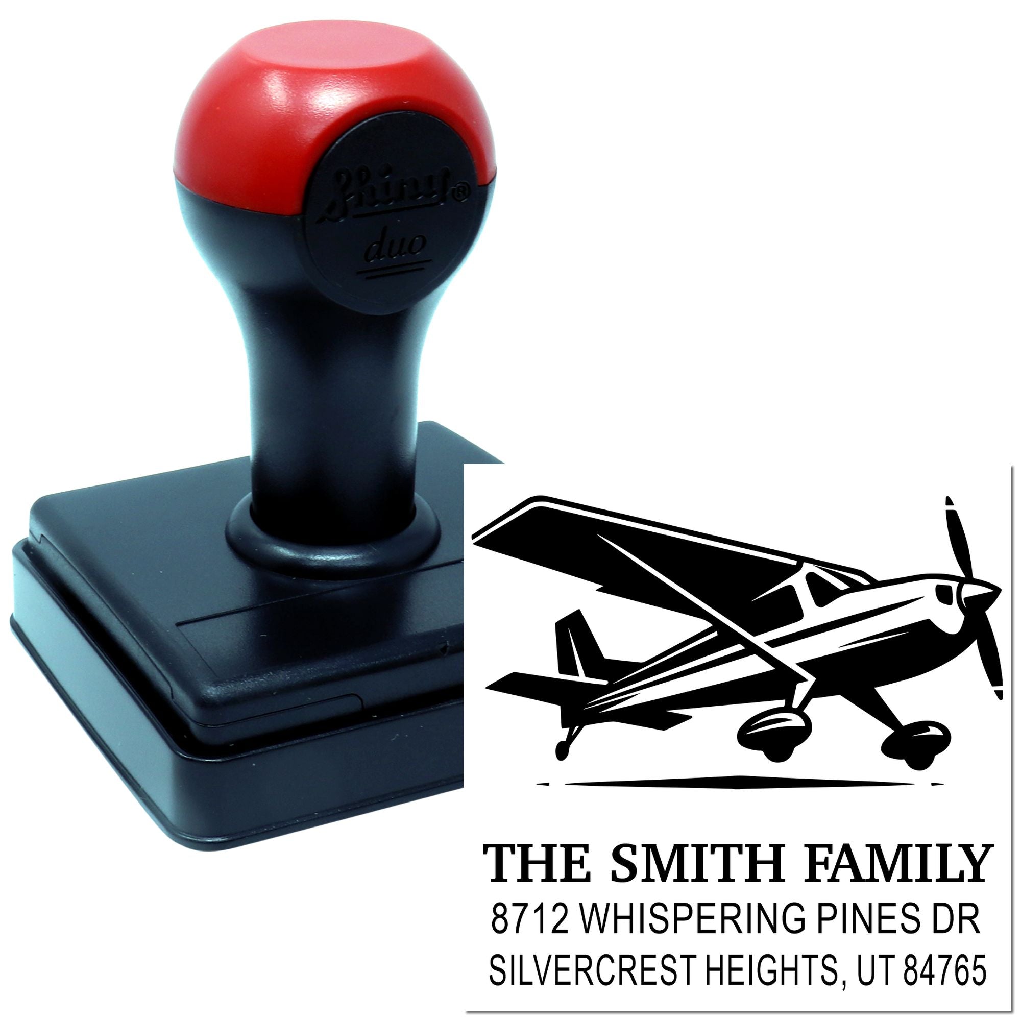Custom self-inking address stamp with airplane design, black and red stamp on white background, featuring The Smith Family return address text.
