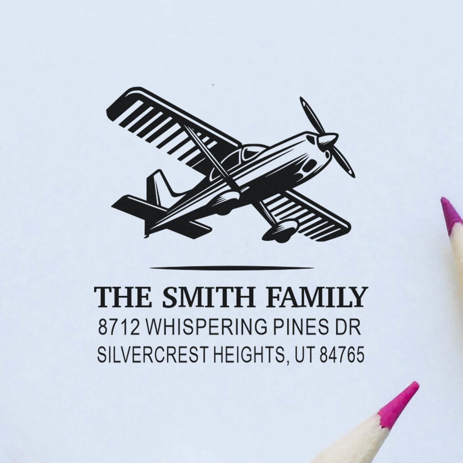 Personalized return address stamp with airplane graphic for The Smith Family, 8712 Whispering Pines Dr, Silvercrest Heights, UT 84765.