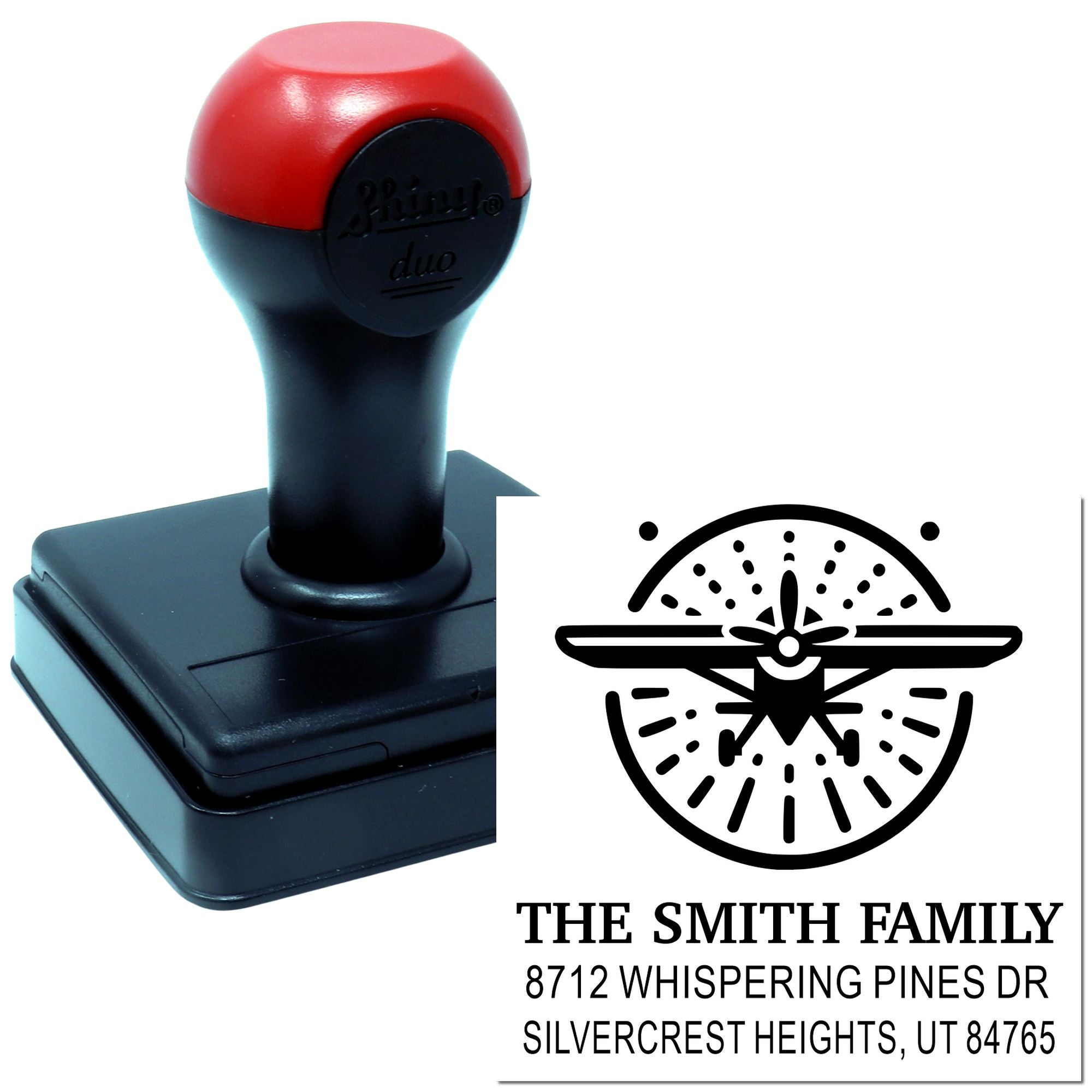 Custom self-inking address stamp with airplane logo, The Smith Family name, and Utah address on a black-and-red stamper.