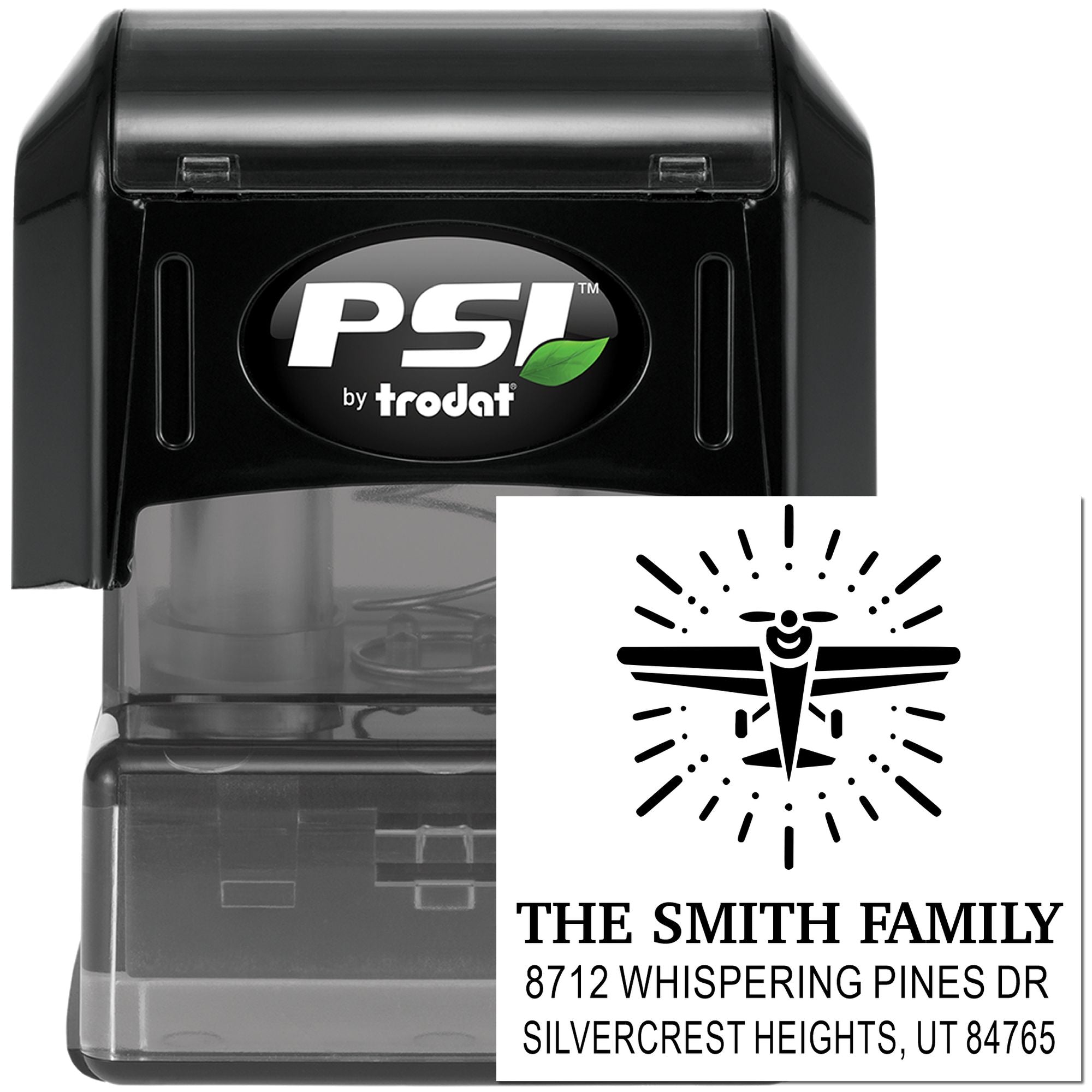 Custom self-inking address stamp by PSI Trodat with dragonfly logo, black casing, and return address sample on white background.