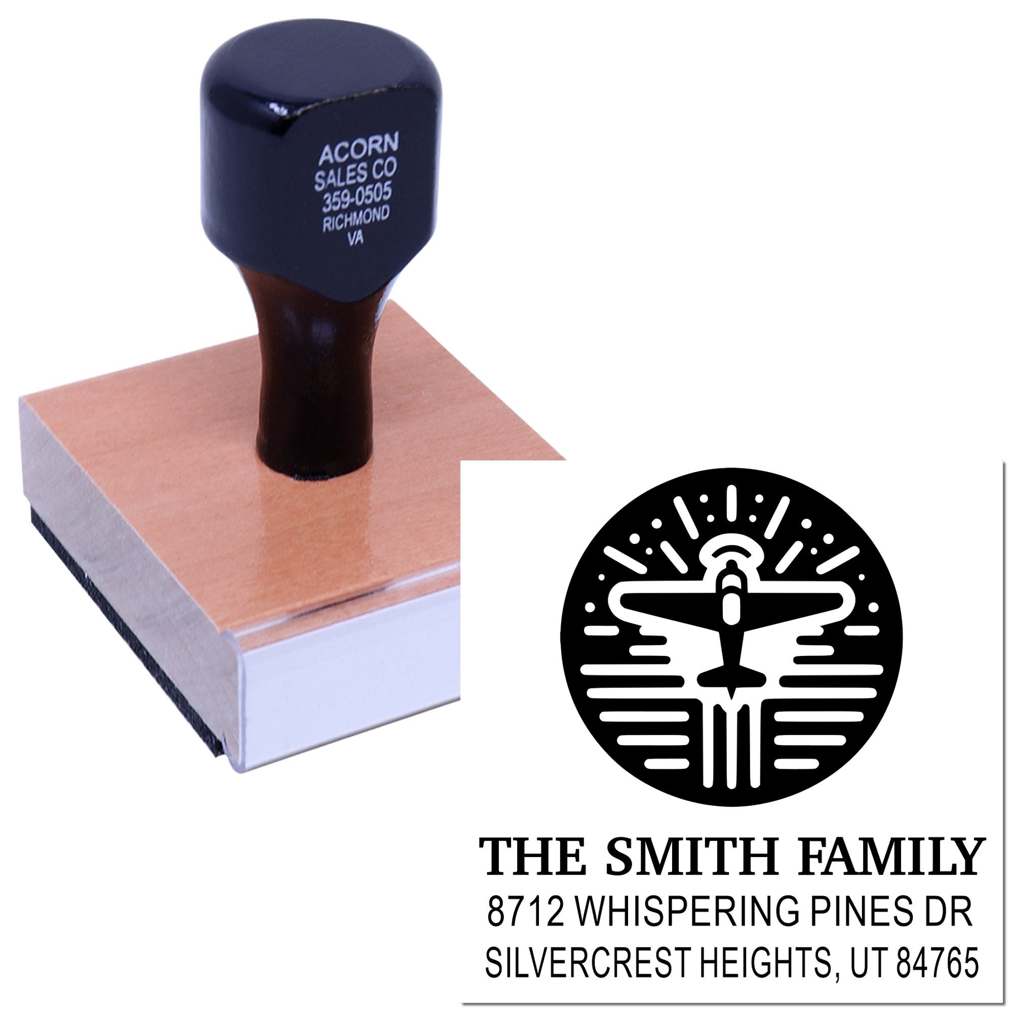 Custom address stamp with airplane logo on wooden handle, stamping a return-address impression for The Smith Family on white paper.