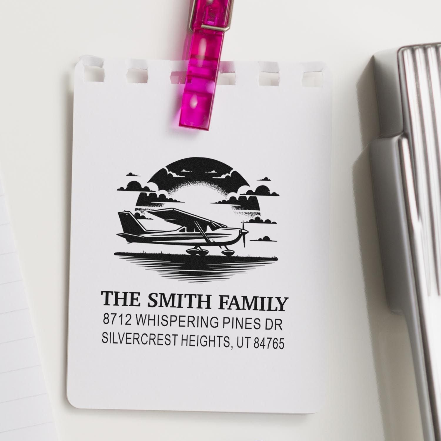Custom return address stamp for The Smith Family, featuring a small airplane graphic on a clipped notepad with name and Utah address.