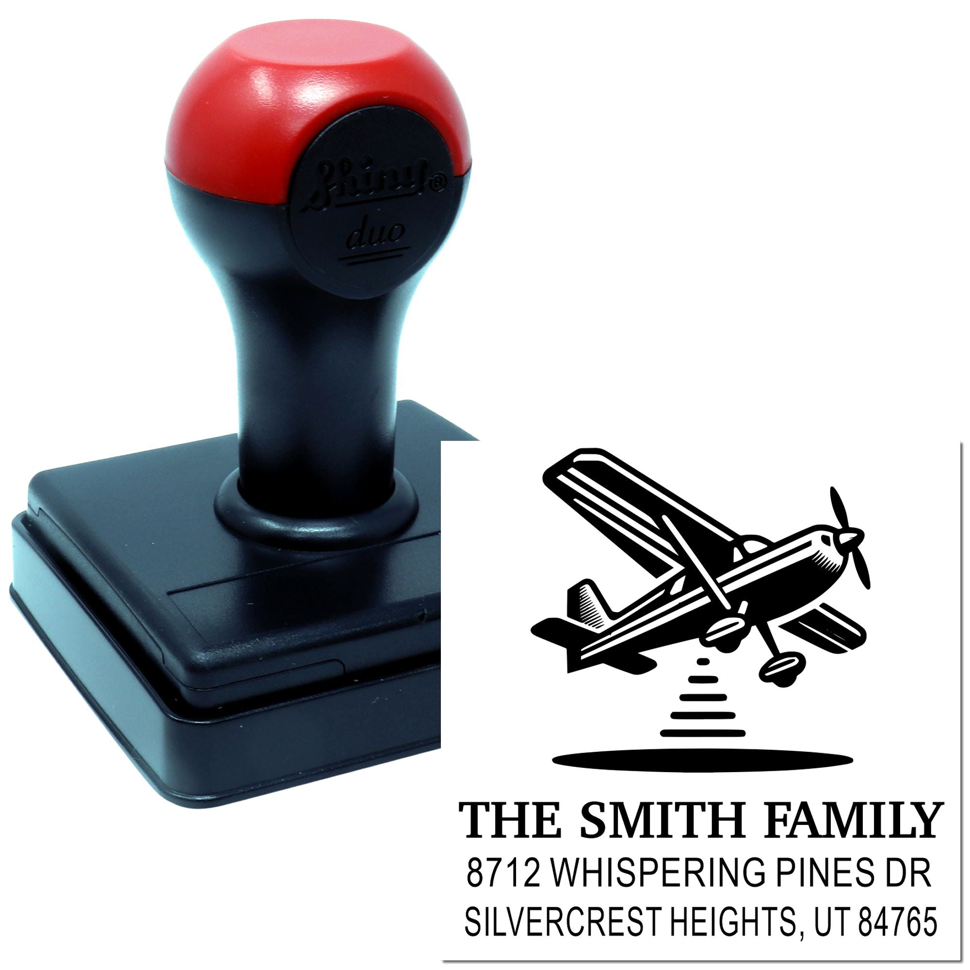 Custom self-inking address stamp with airplane design and The Smith Family address on a white background.
