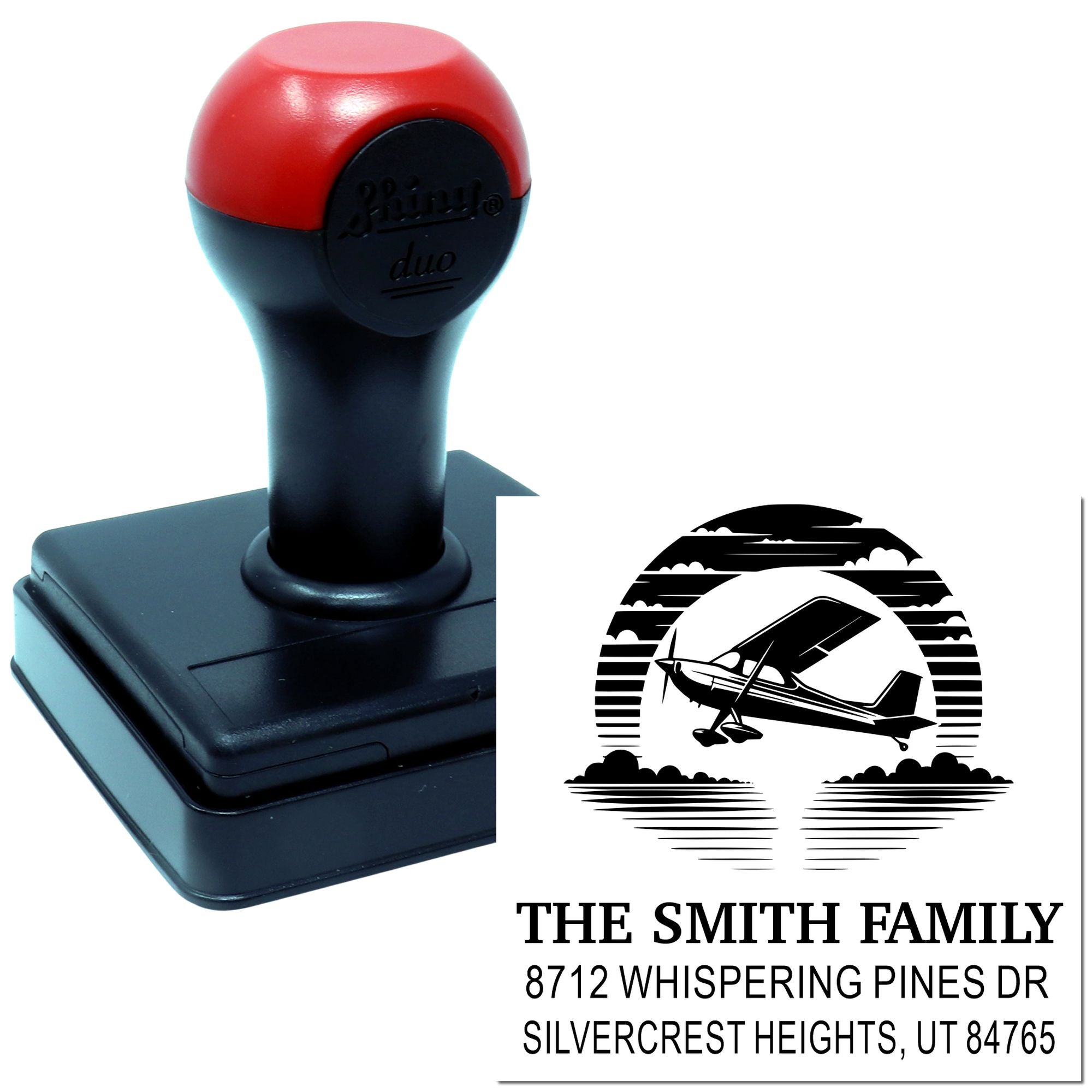 Custom self-inking stamp with airplane logo and Smith family address, shown beside the printed impression on a white background.