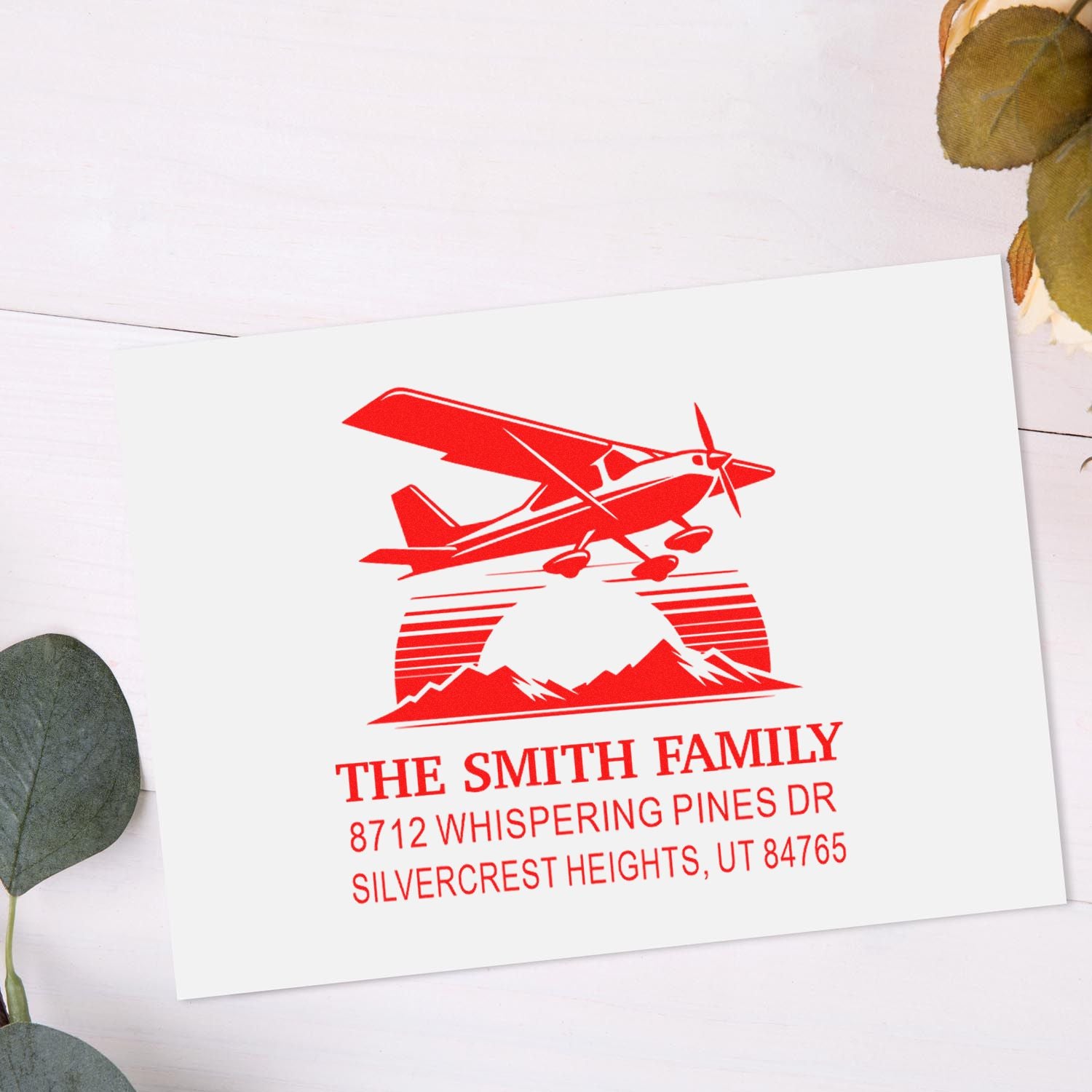 Custom red address stamp with vintage airplane and mountain logo on white card, personalized for The Smith Family in Silvercrest Heights, UT.