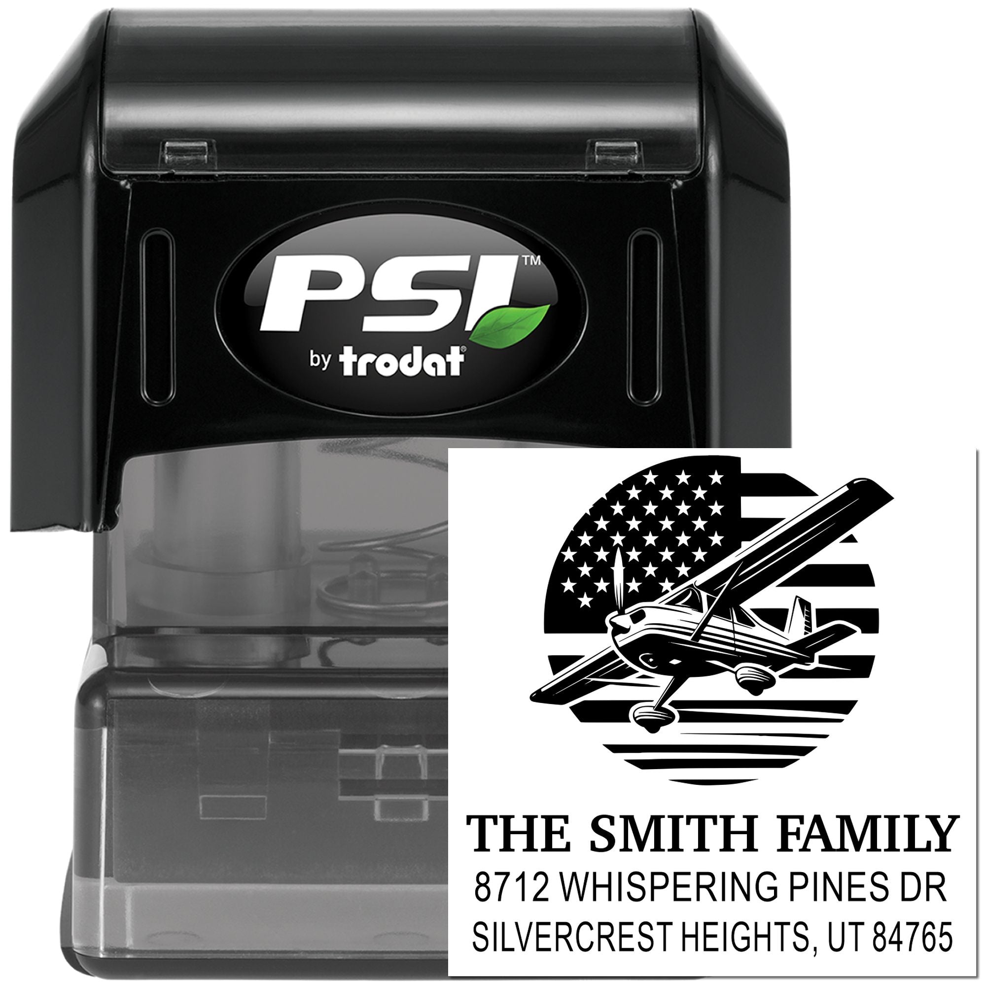 Custom self-inking address stamp by PSI Trodat with airplane logo, family name, and return address imprint on a black stamp case.