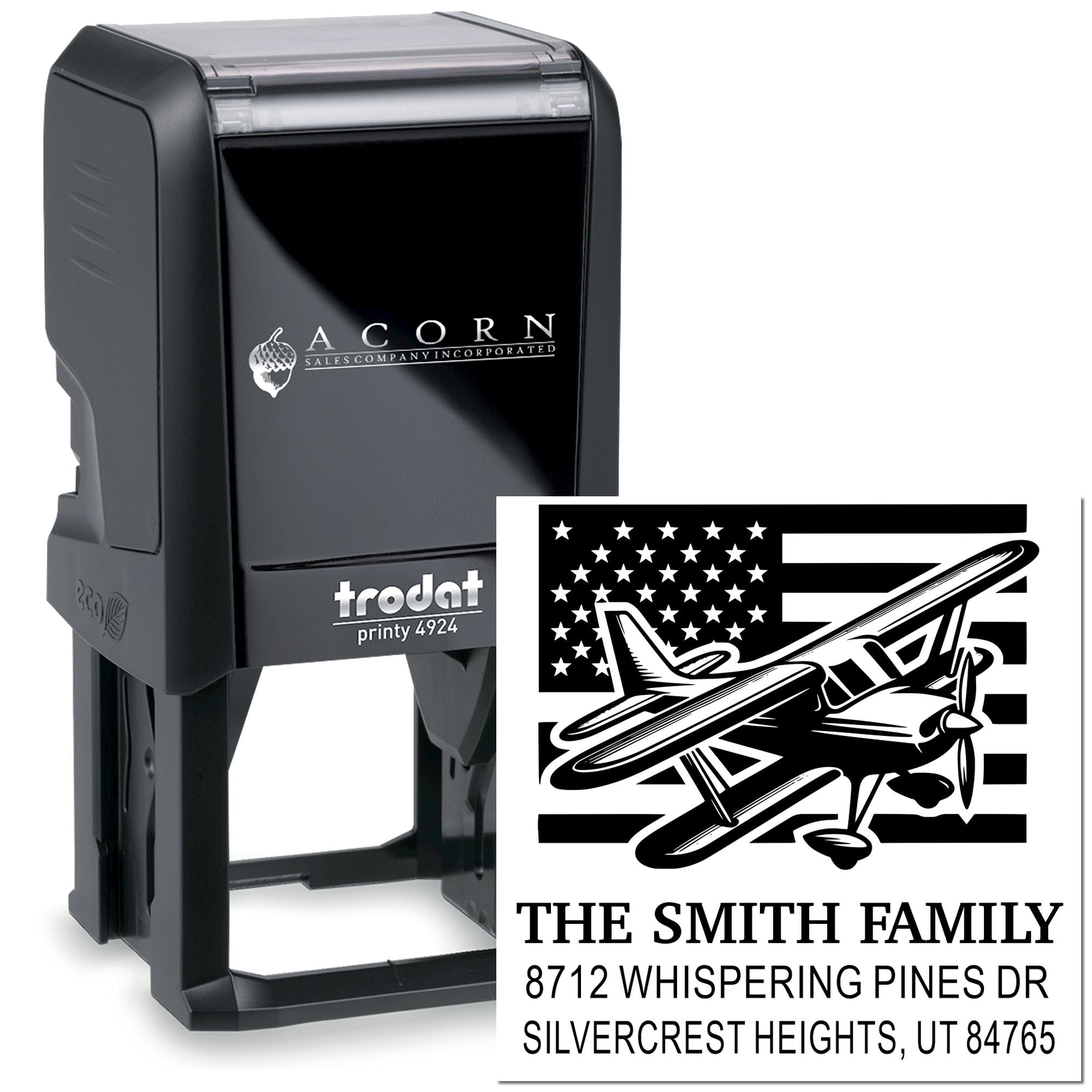 Trodat Printy 4924 self-inking stamp with custom family address imprint, featuring a vintage airplane over a U.S. flag on a white background.