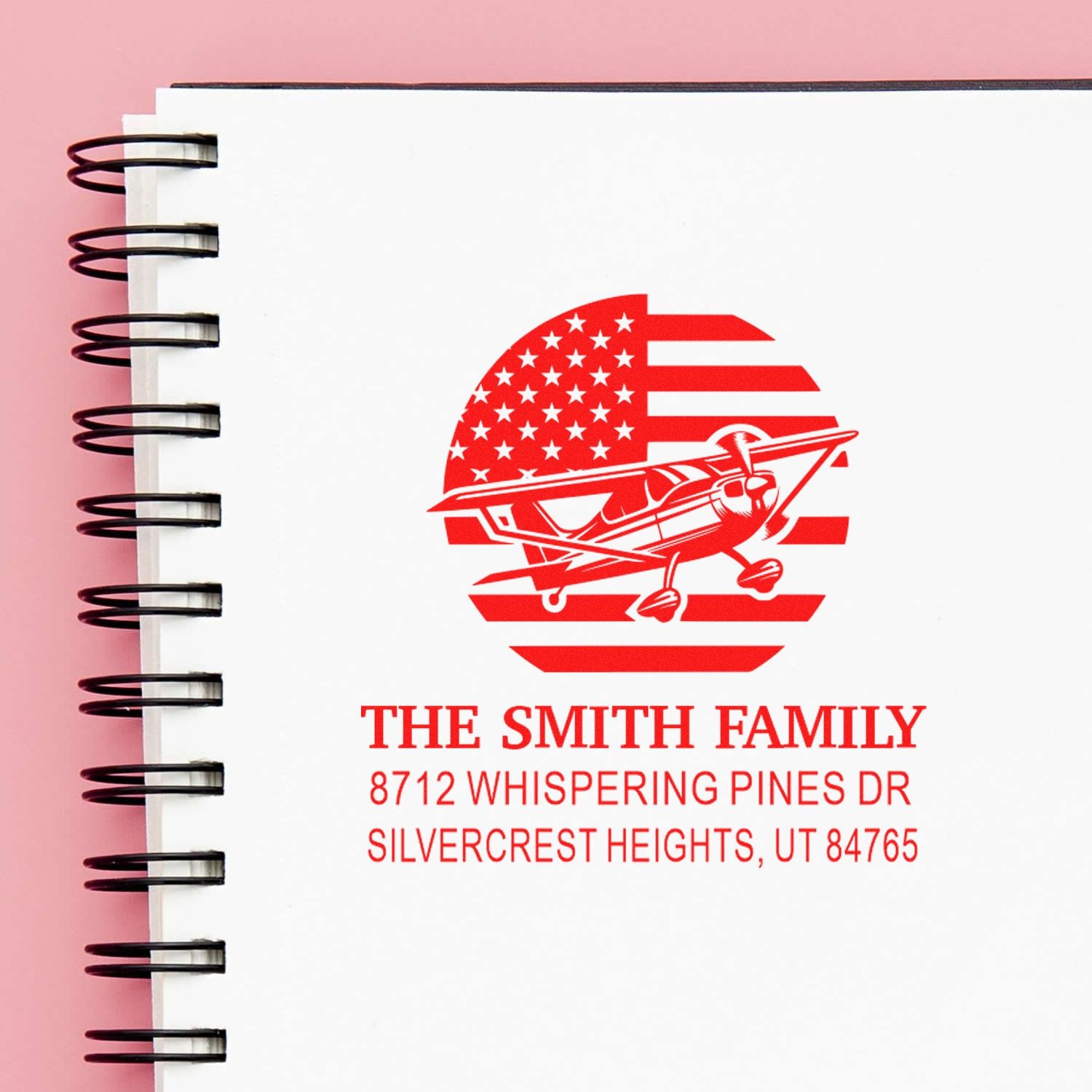 Custom red address stamp with American flag and airplane design on a white notebook page, featuring The Smith Family, Whispering Pines Dr, Silvercrest Heights, UT.