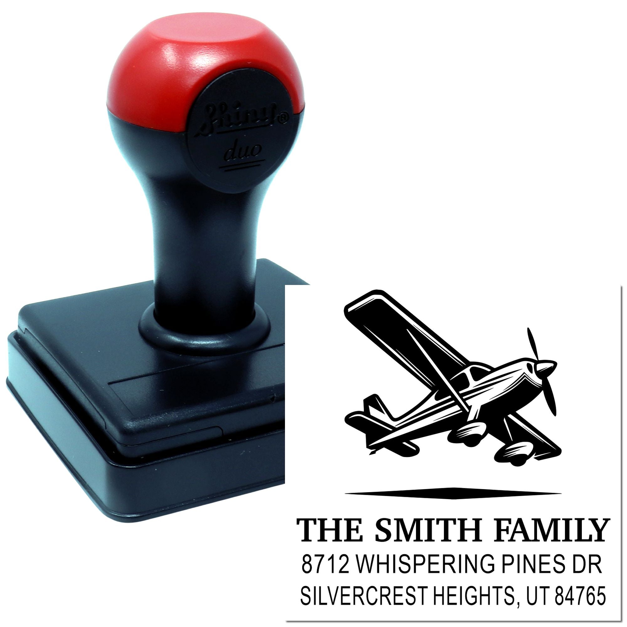 Personalized self-inking address stamp with airplane logo and Smith family return address on a black and red stamp base.