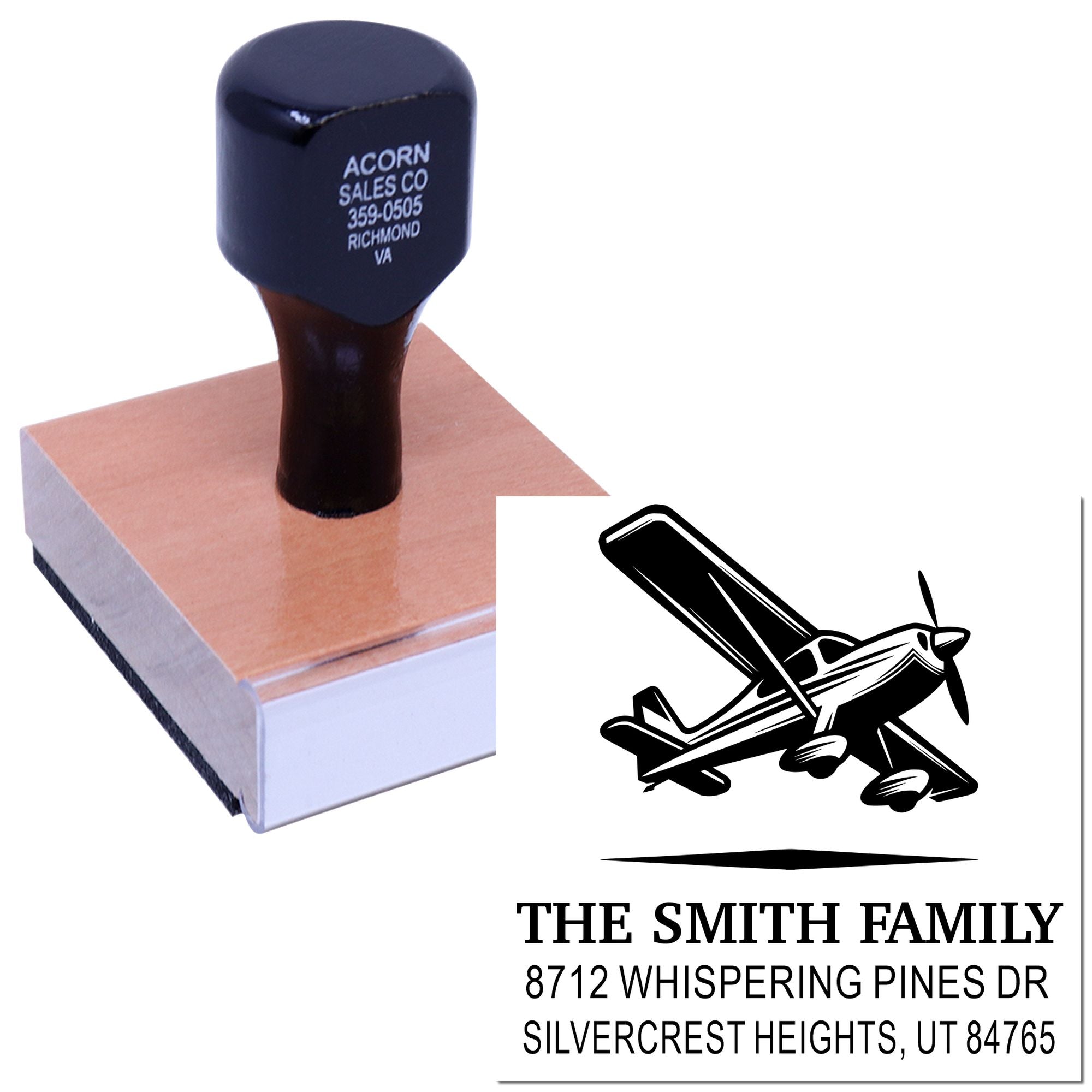 Custom rubber address stamp with airplane design, shown pressing onto a block and imprinting The Smith Family return address.