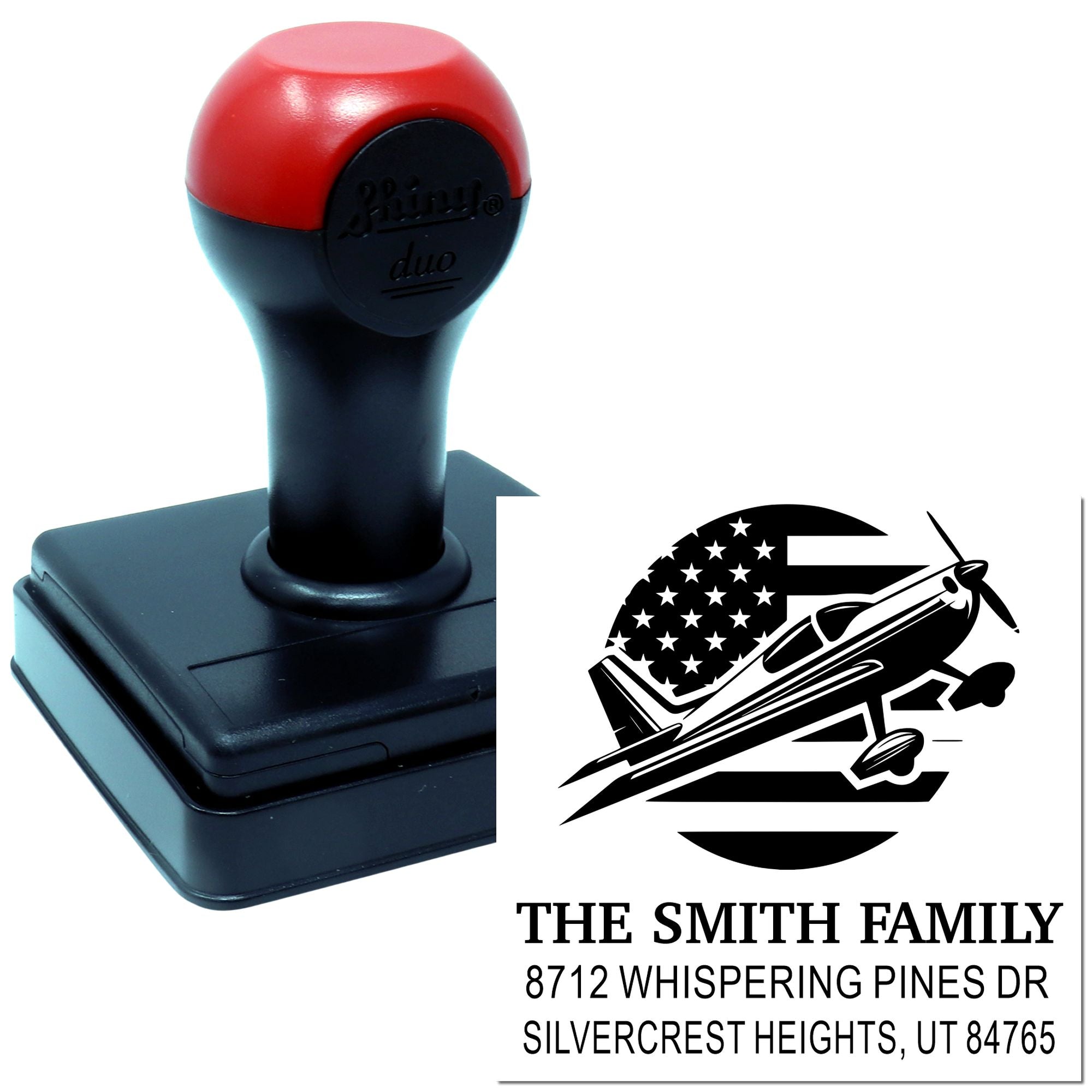 Personalized self-inking stamp with airplane design and The Smith Family address, shown beside custom imprint on a white background.