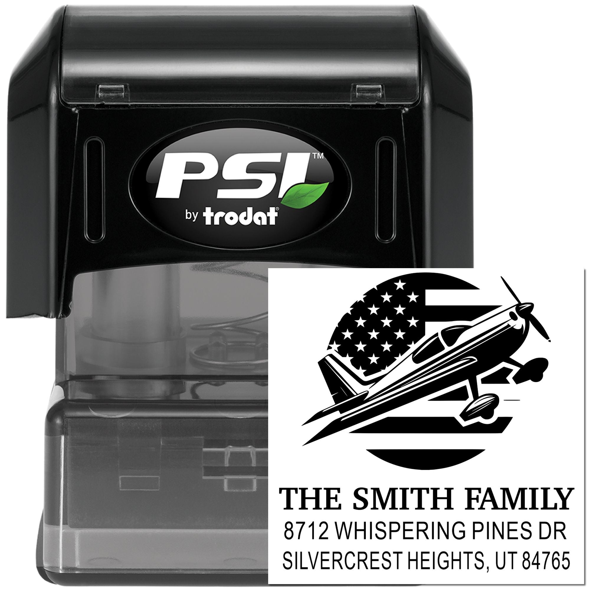 PSI by Trodat self-inking address stamp with airplane design, custom family name imprint, and black stamp case on a white background.