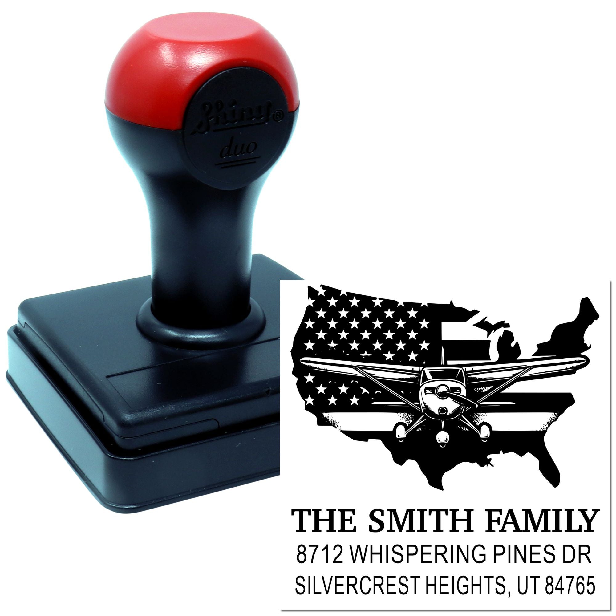 Self-inking custom address stamp with airplane USA design and Smith family name, shown with black and red stamp base on a white background.
