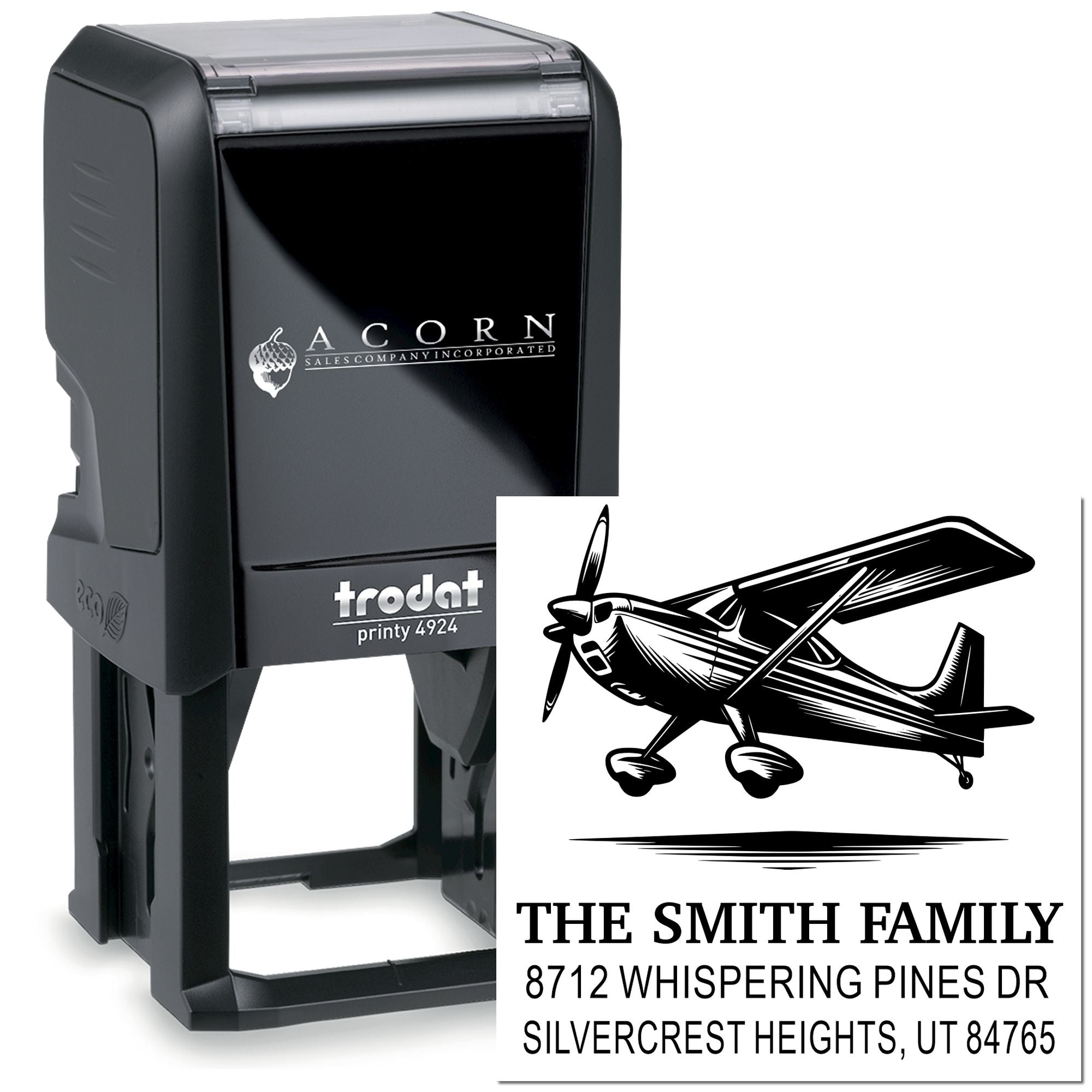 Custom self-inking Trodat Printy 4924 address stamp with airplane graphic, shown beside its imprint on a white background.