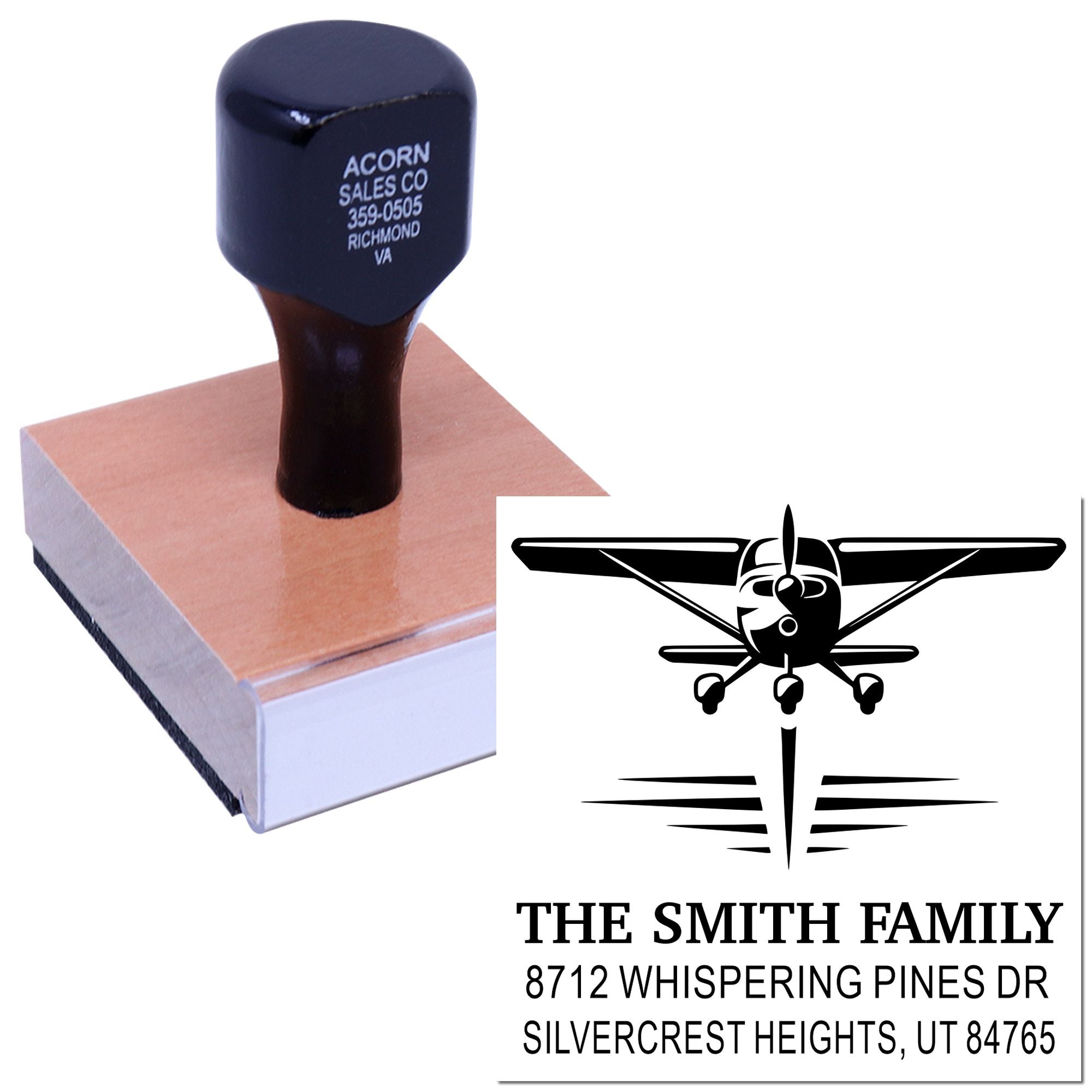 Custom family address stamp with airplane logo, showing a clean black imprint and stamp block on a white background.