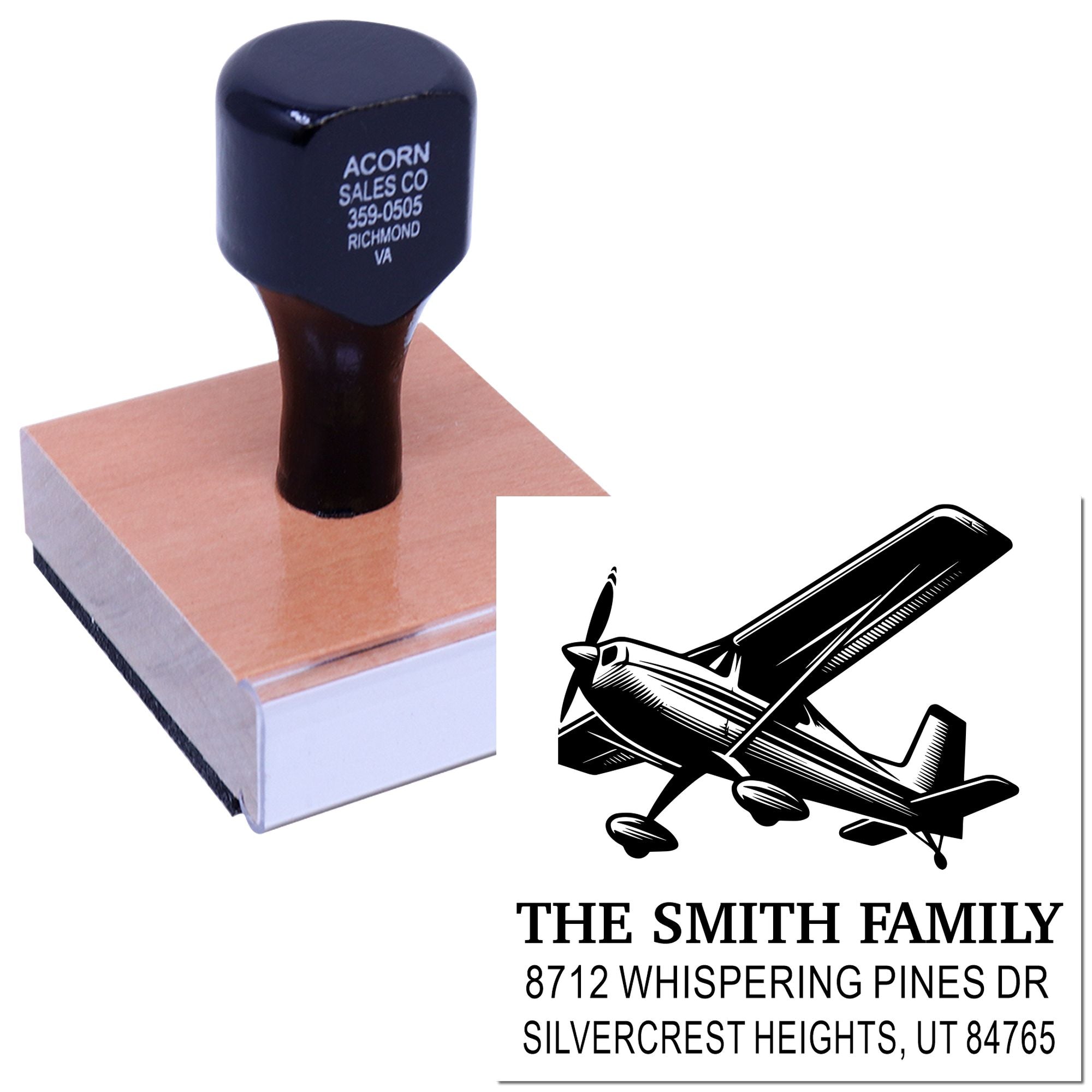 Custom rubber address stamp with airplane logo, The Smith Family name, and mailing address on a wooden base against a white background.