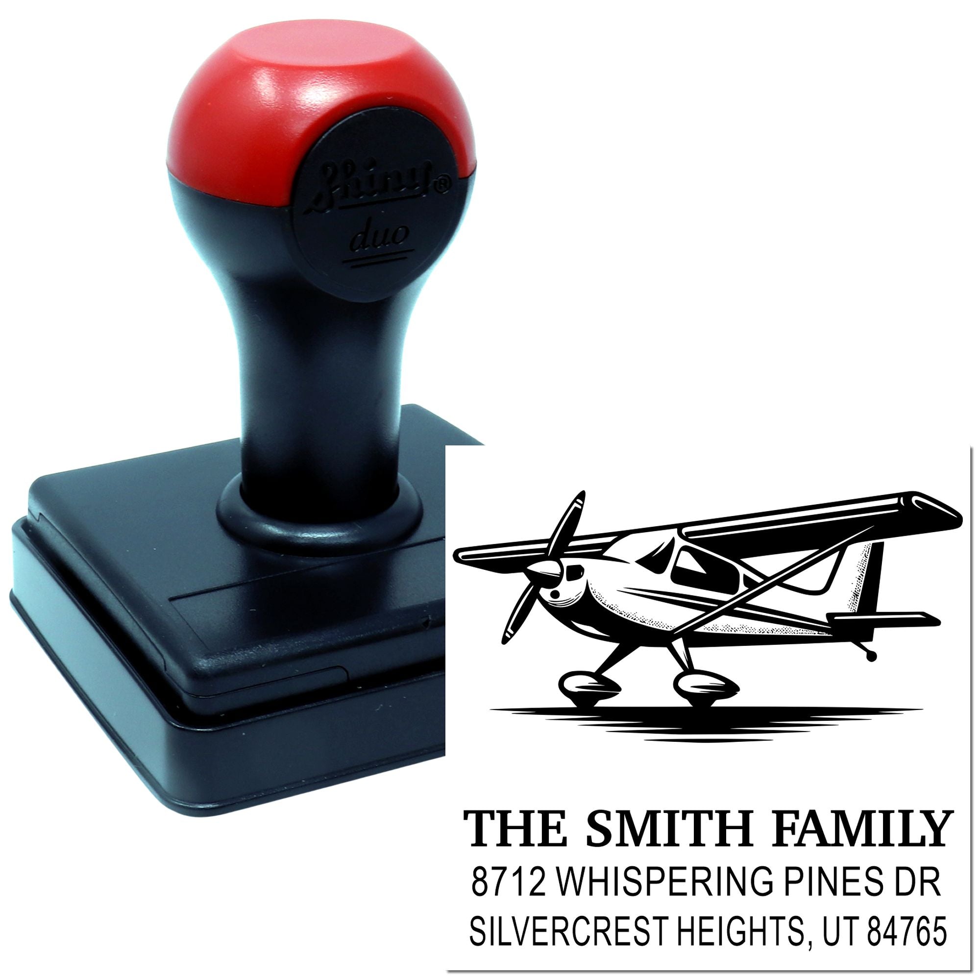 Custom self-inking address stamp with airplane logo and Smith family details, shown beside its black stamped imprint on a white background.