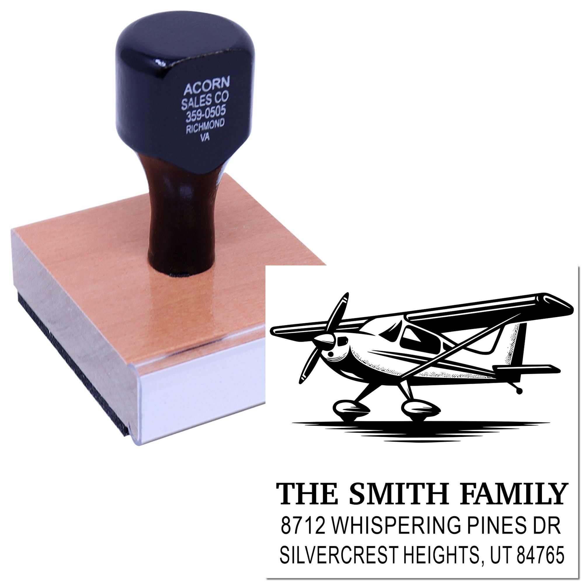 Custom self-inking address stamp with airplane graphic, showing The Smith Family and Utah address, pressed on a wooden block.