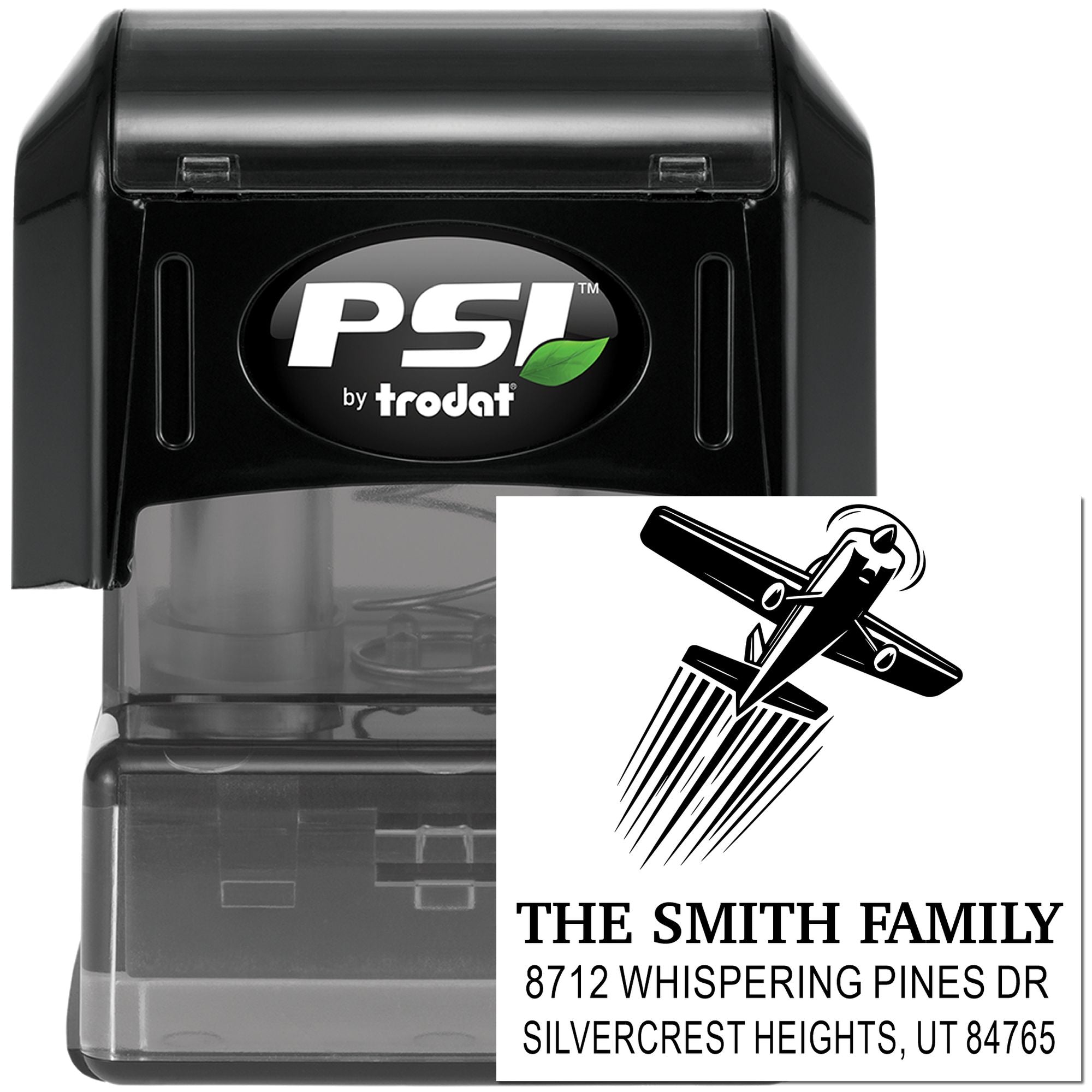 PSI by trodat self-inking address stamp with family name, return address, and decorative monogram design on a black stamp body