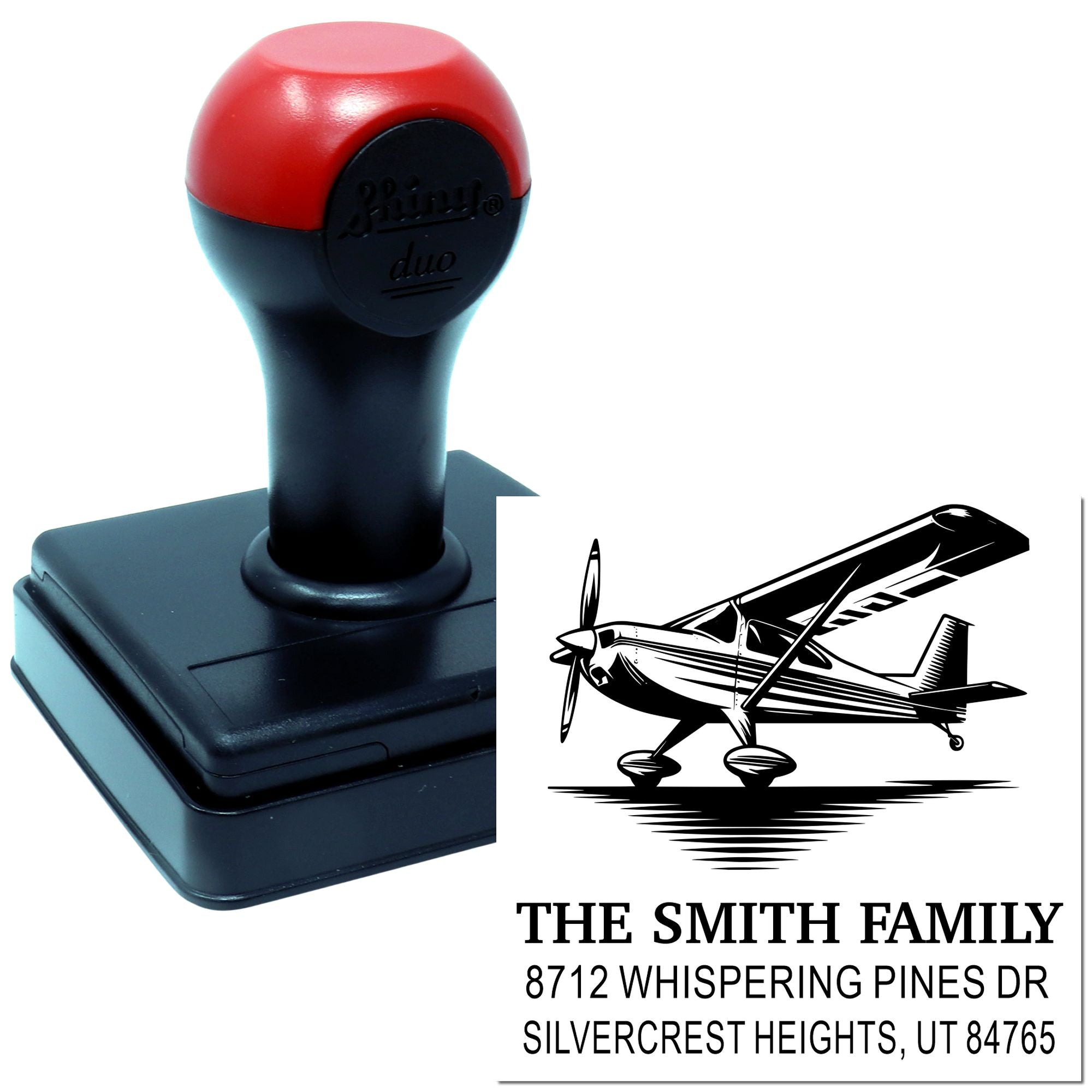 Personalized self-inking stamp with airplane graphic, showing The Smith Family address on a white background.